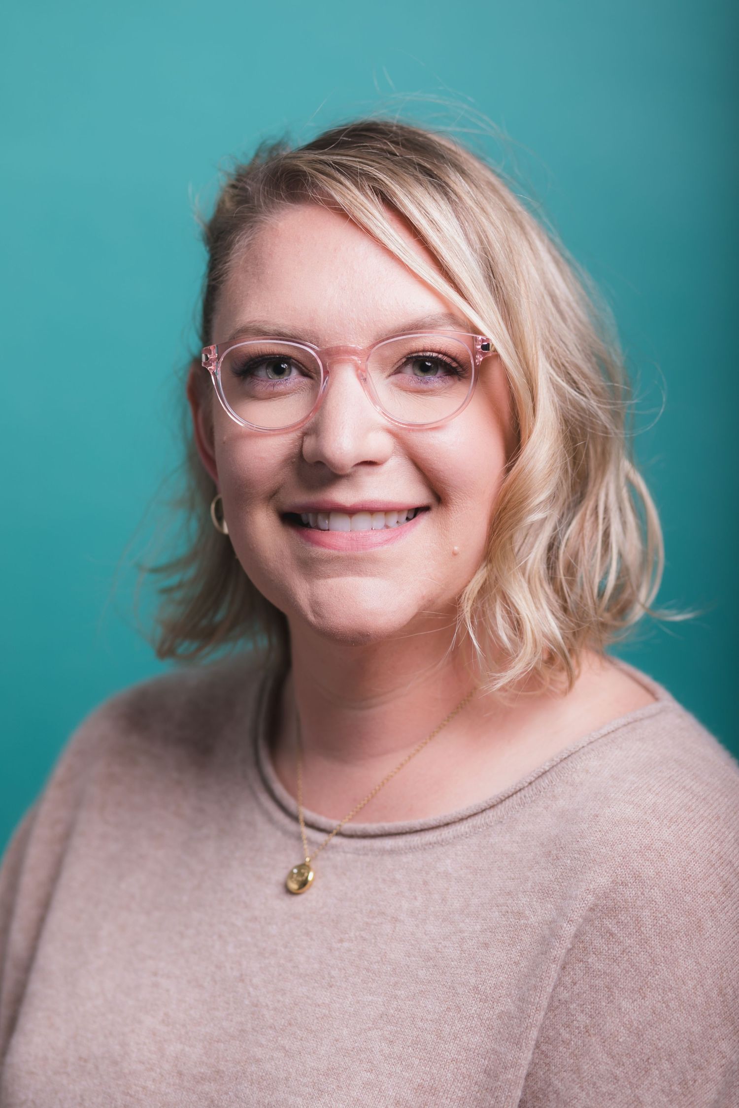 Portrait series of person in beige sweater against turquoise background.