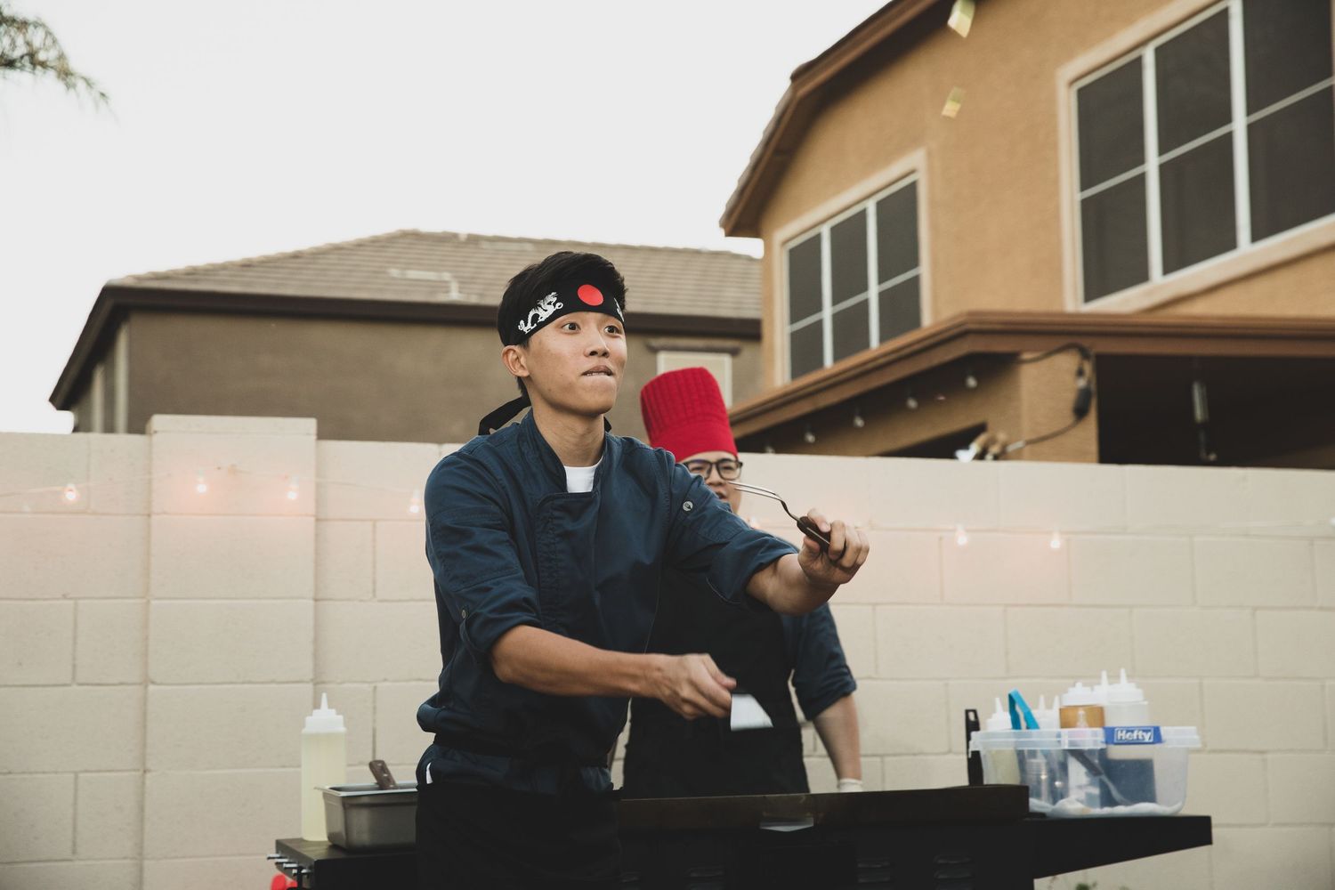 Professional bartender mixing drinks at an outdoor event station.