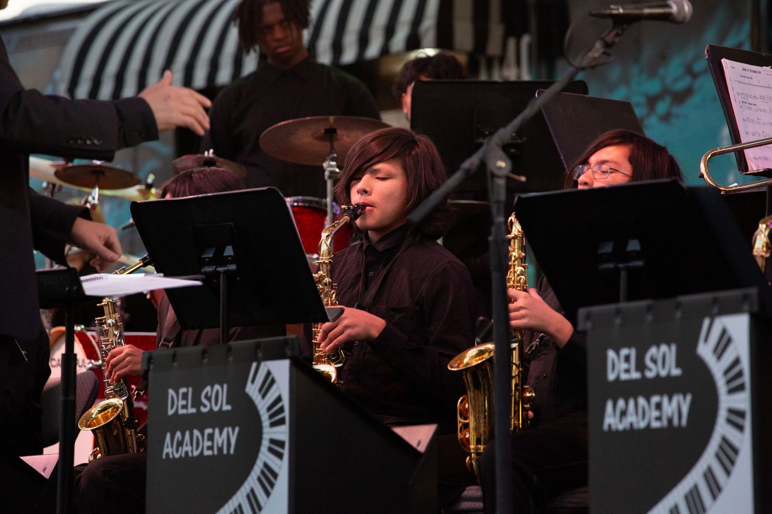 Student jazz band performs at Del Sol Academy with saxophone section in focus.