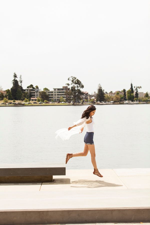 Dynamic sequence of jumping movements against a waterfront backdrop.