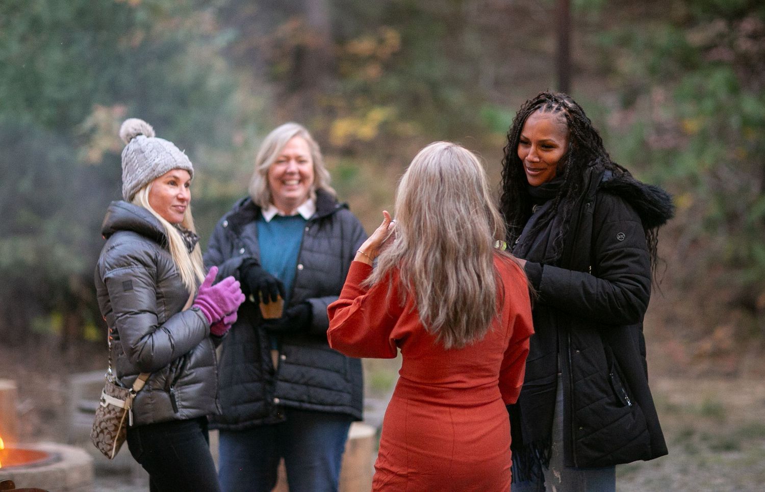Groups gathered at an outdoor social event with twinkling lights.