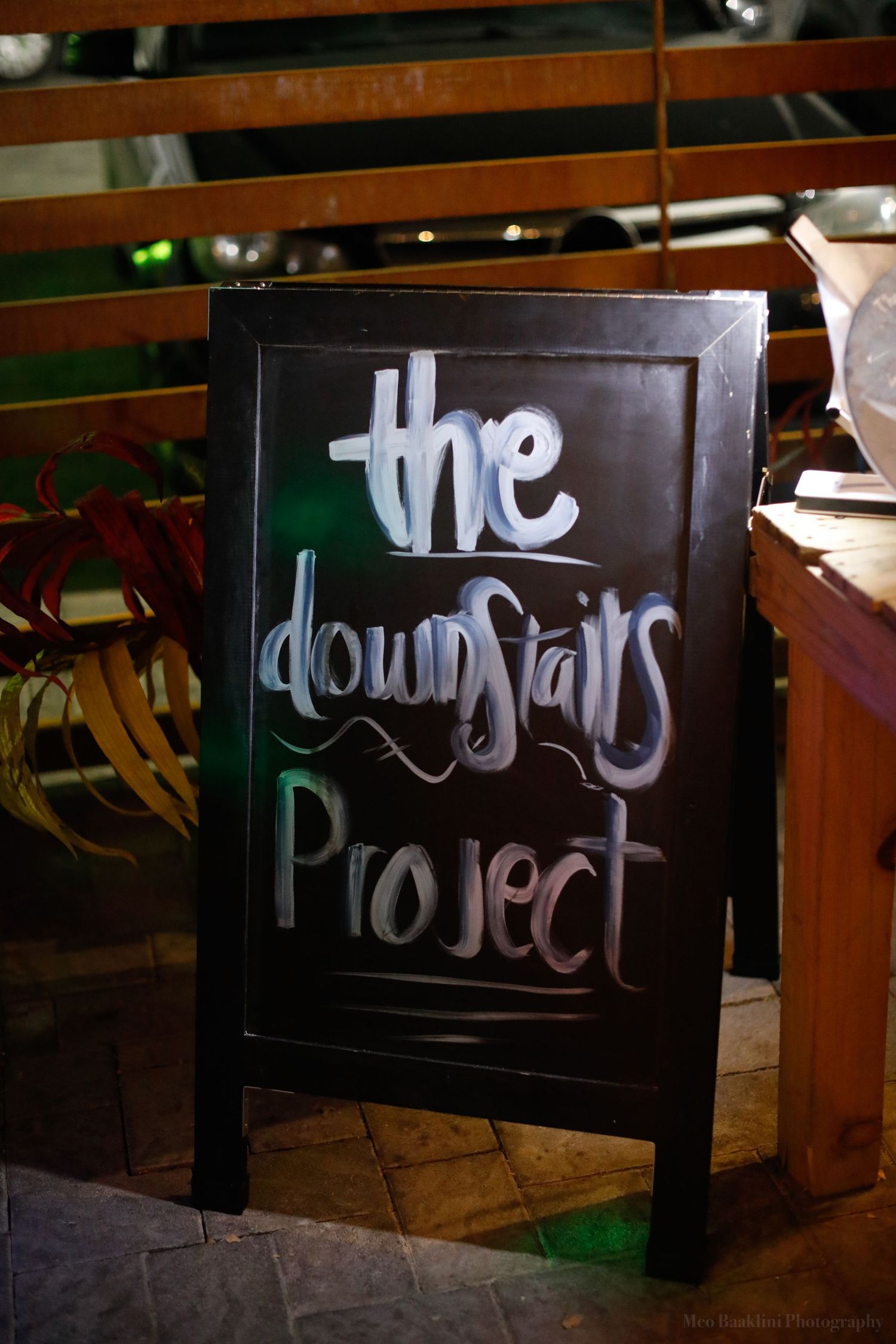 Black sign with 'The Project' text in artistic lettering.