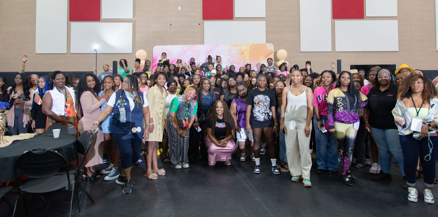 Large group photo of diverse event attendees gathered in conference space.