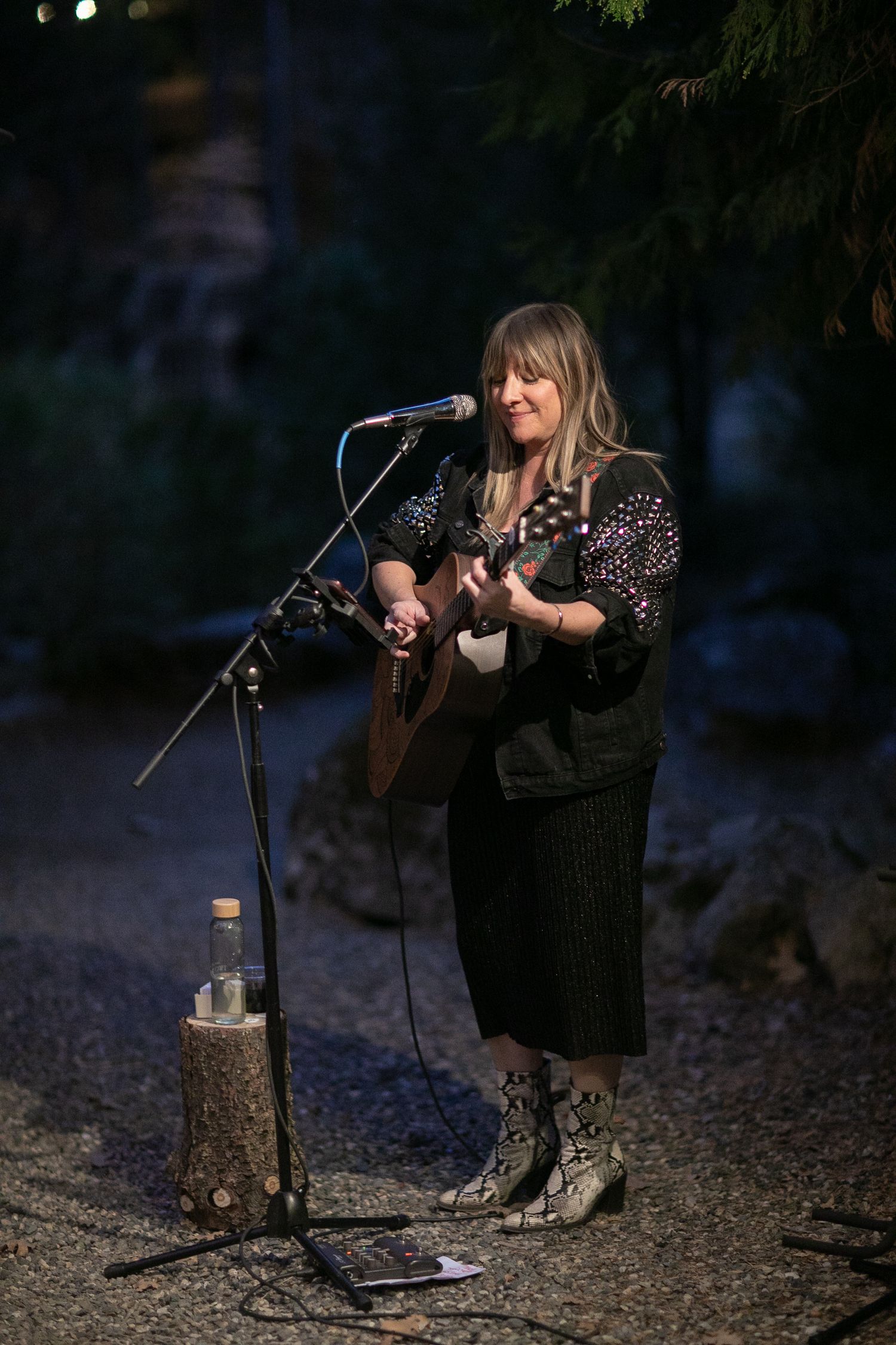 Musicians performing at a nighttime outdoor gathering.
