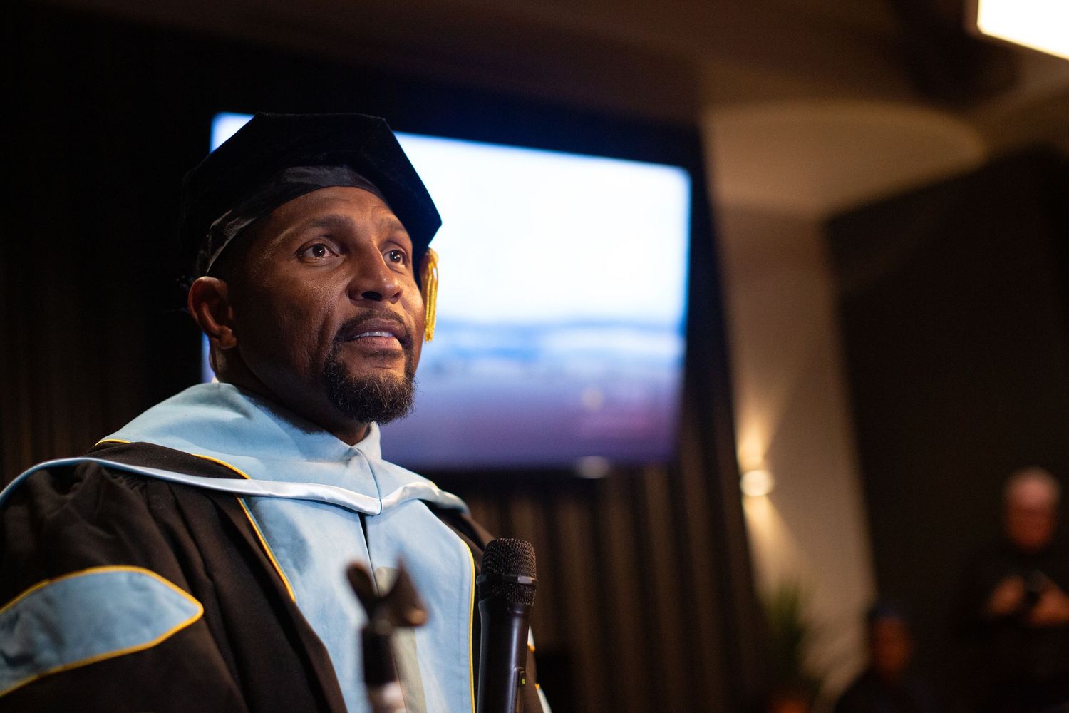Graduates in academic regalia participating in a commencement ceremony.