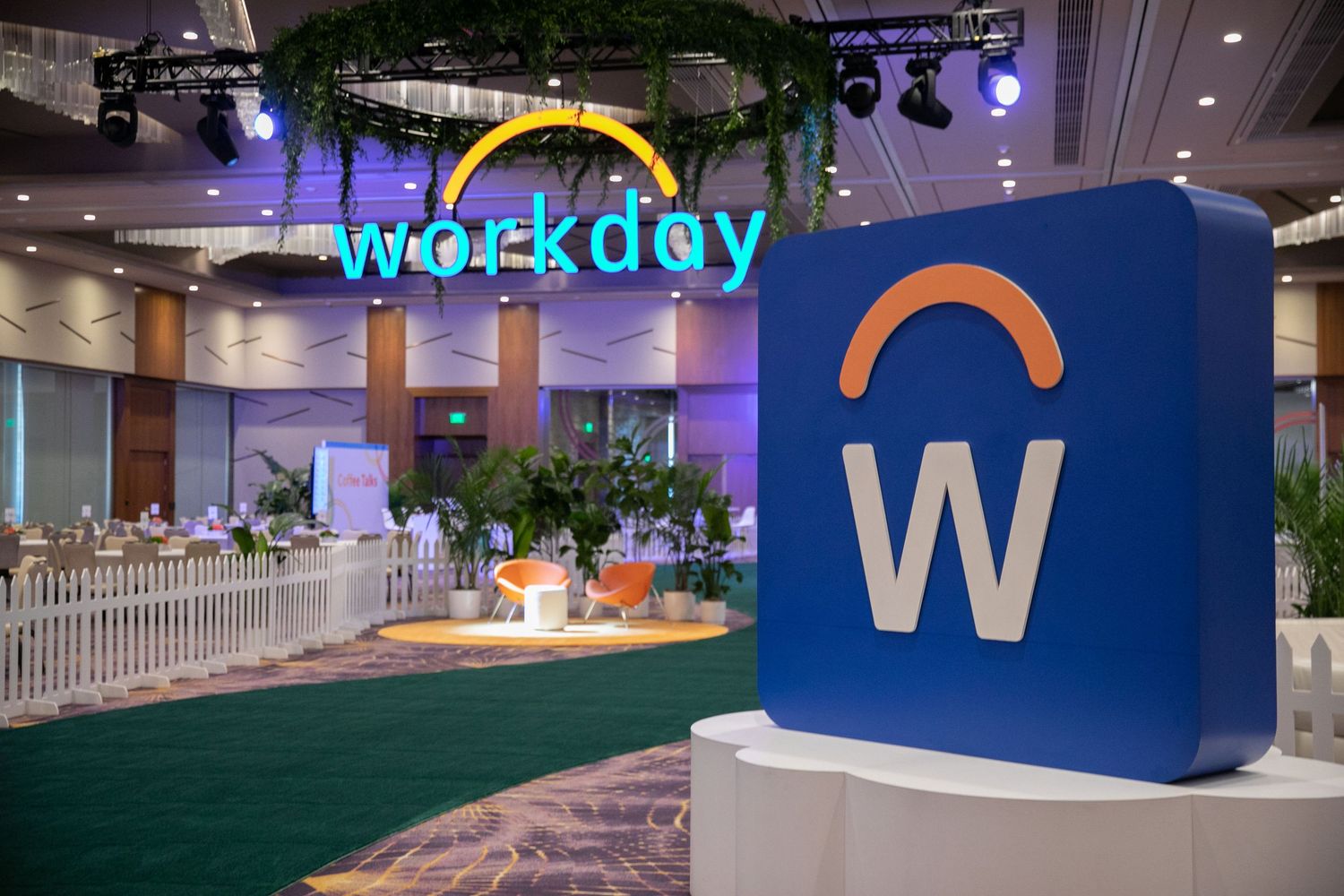 Workday corporate event space with illuminated logo and artificial grass display.
