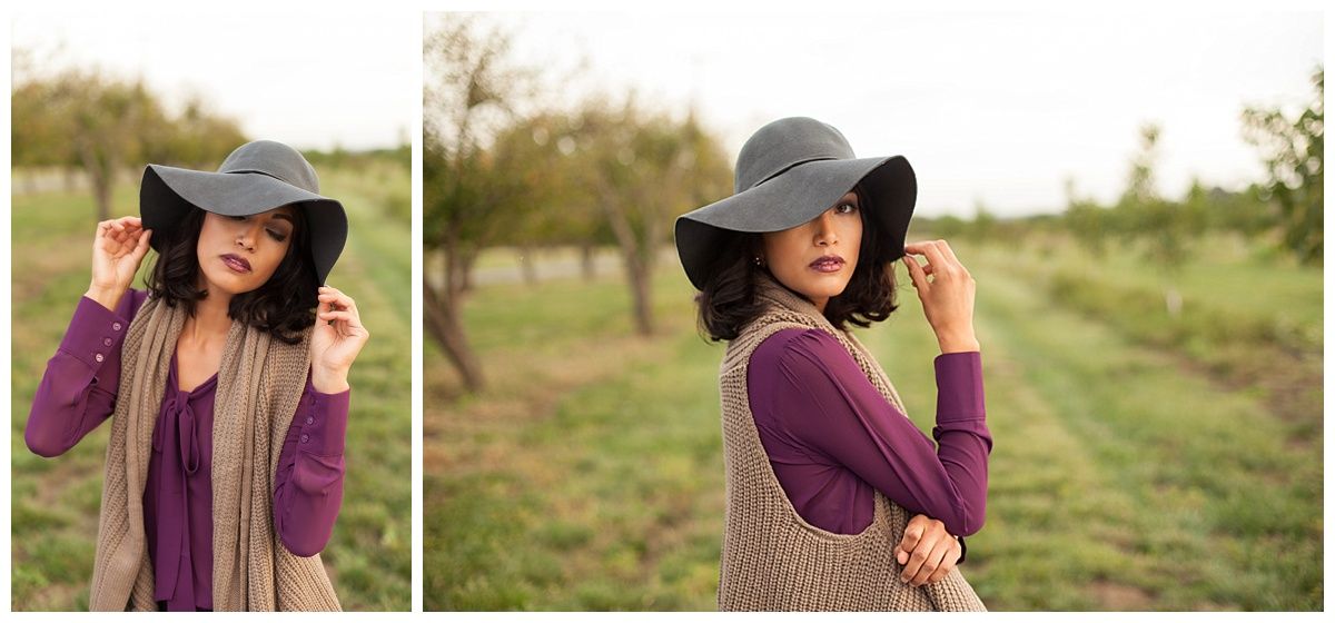 Outdoor fashion photography in field wearing burgundy scarf and floppy hat.