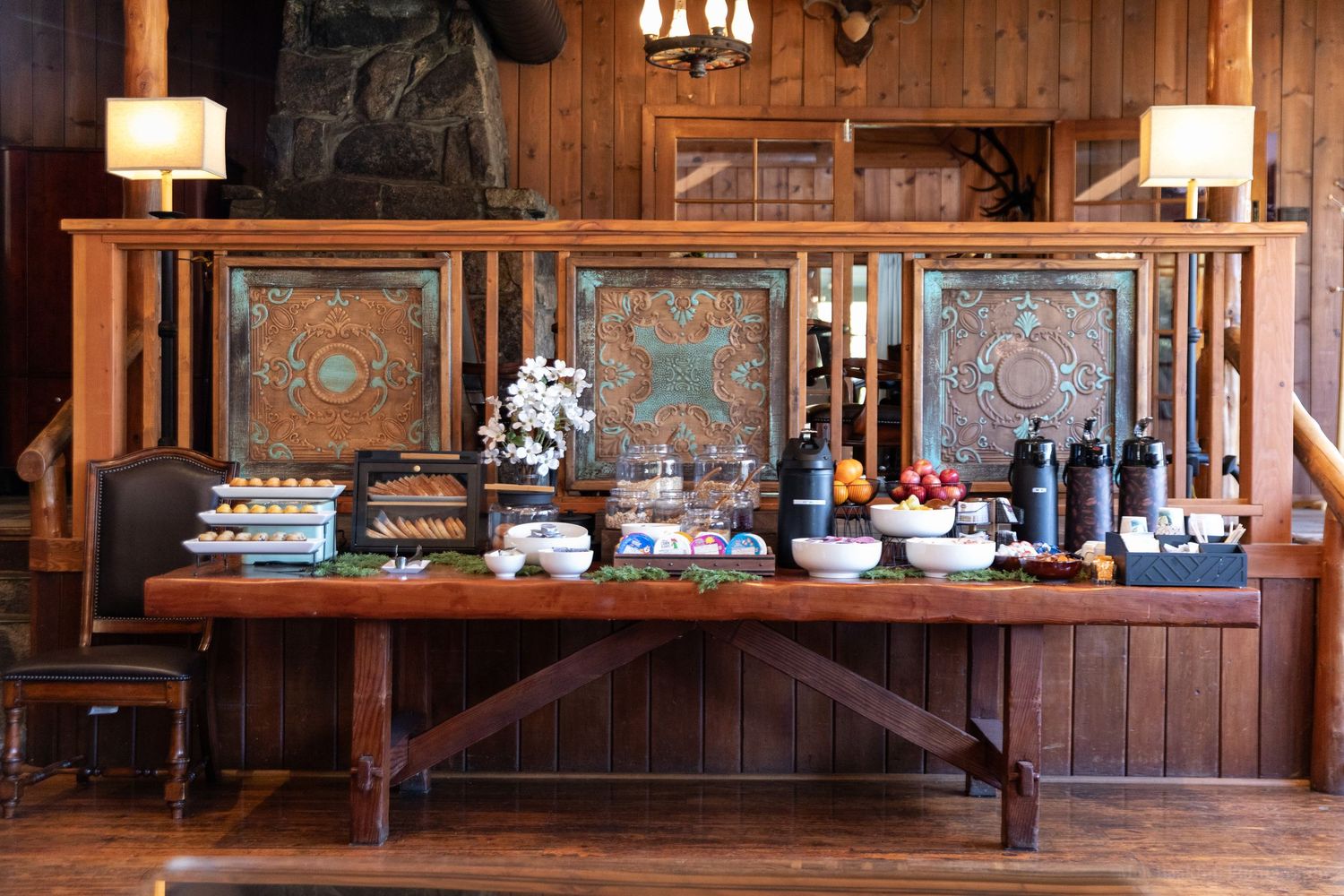 Elegant buffet setup with carved wooden panels and decorative displays at an upscale venue.