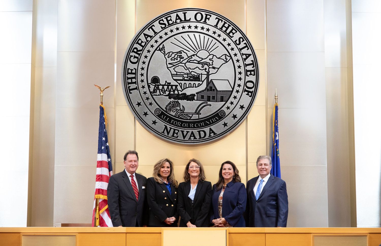 Official government seal with American flags displayed in a formal setting.