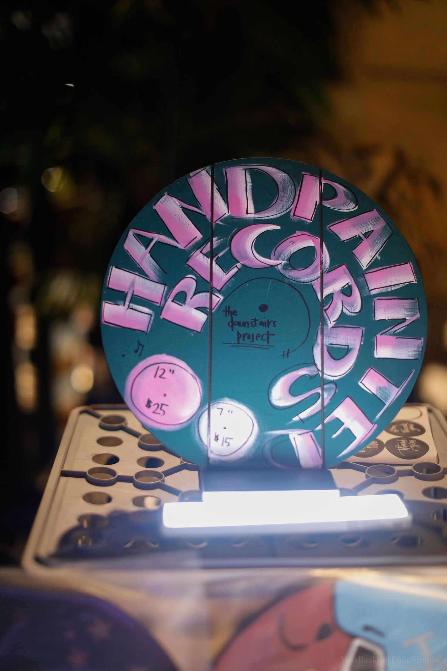 Decorative teal and pink art installation with curved text design.