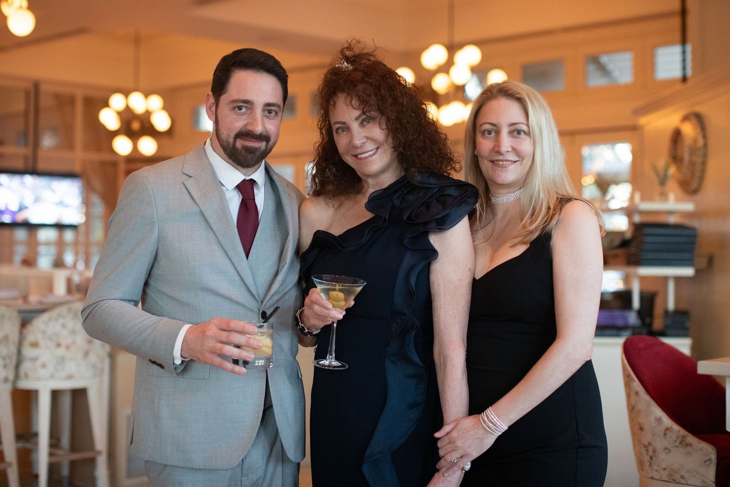 Guests mingling and socializing at an elegant indoor celebration event.