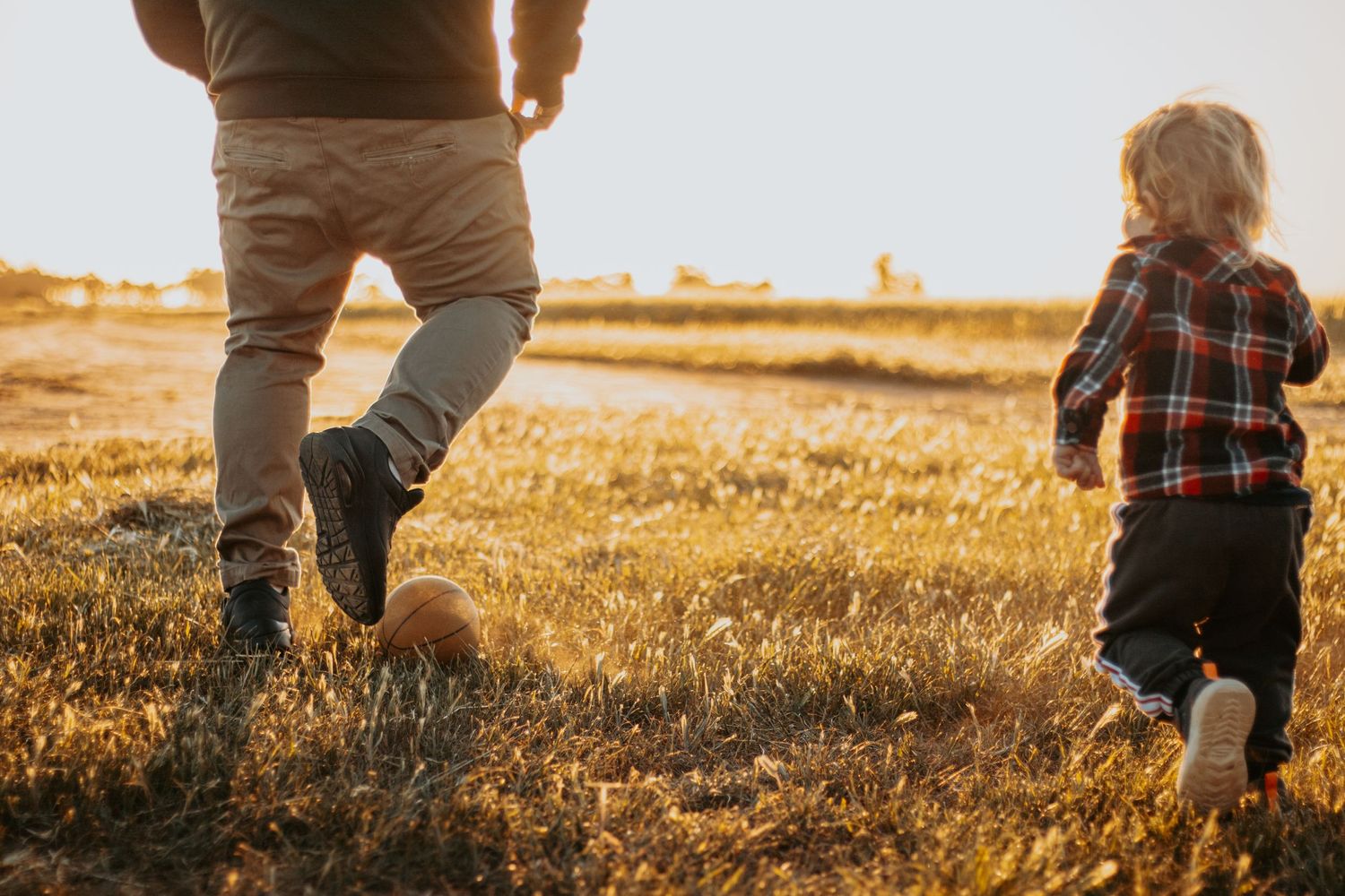 candid father son playing farm outdoor setting