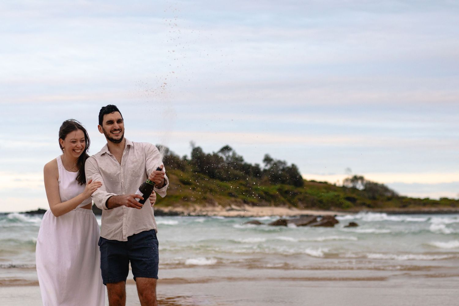 engagement champagne shower photo on beach
