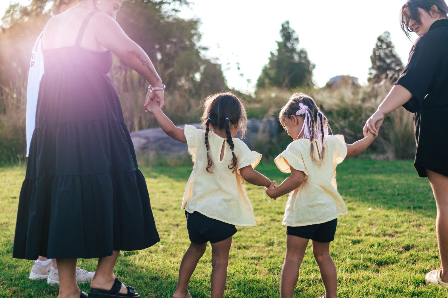 family photo sunset green grass candid holding hands