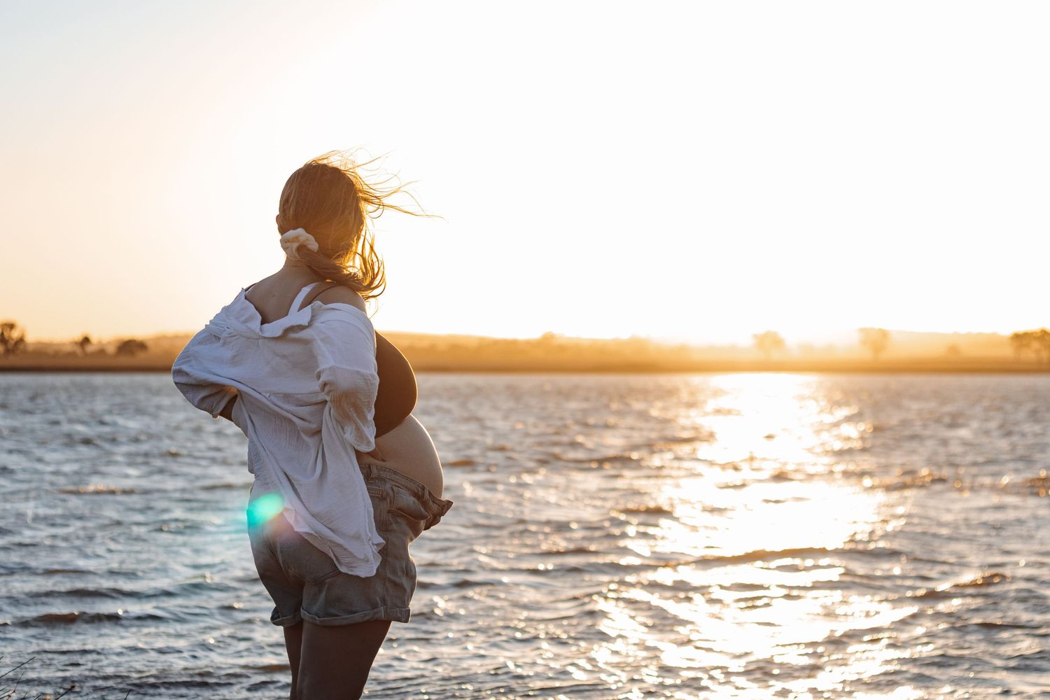 Maternity sunset evening photo session. Water lake gorgeous candid.