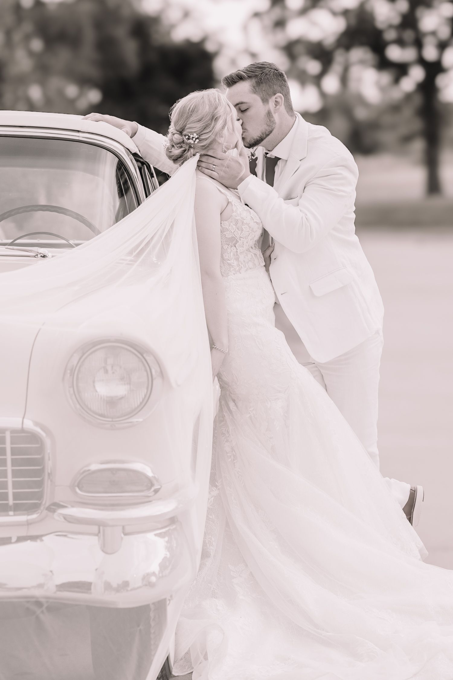 Romantic Wedding Photo of bride and groom at the Brownstone in Topeka, Kansas. With old car.
