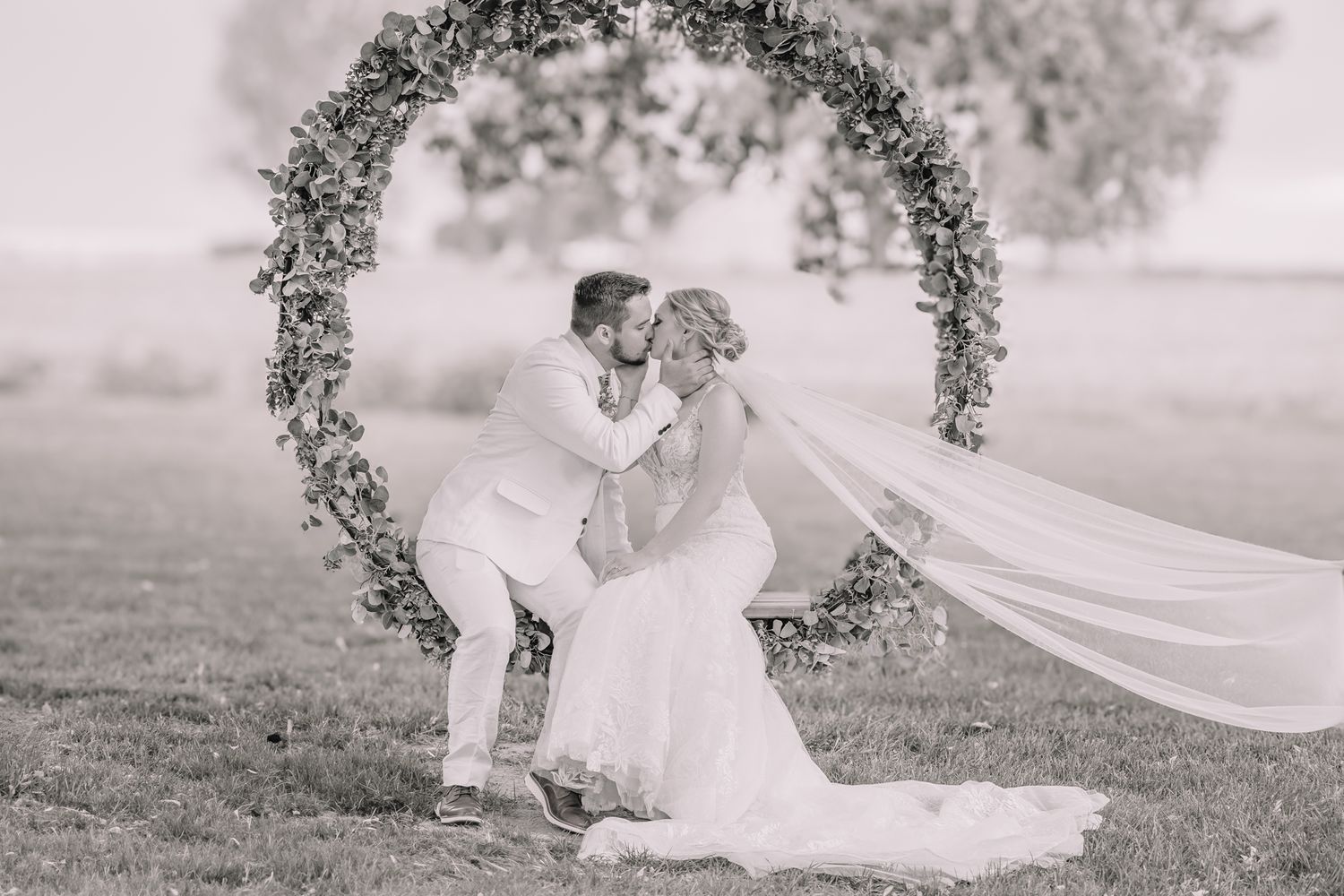Romantic photo of bride and groom. at the Brownstone on the swing. Wedding photos in Topeka, KS.