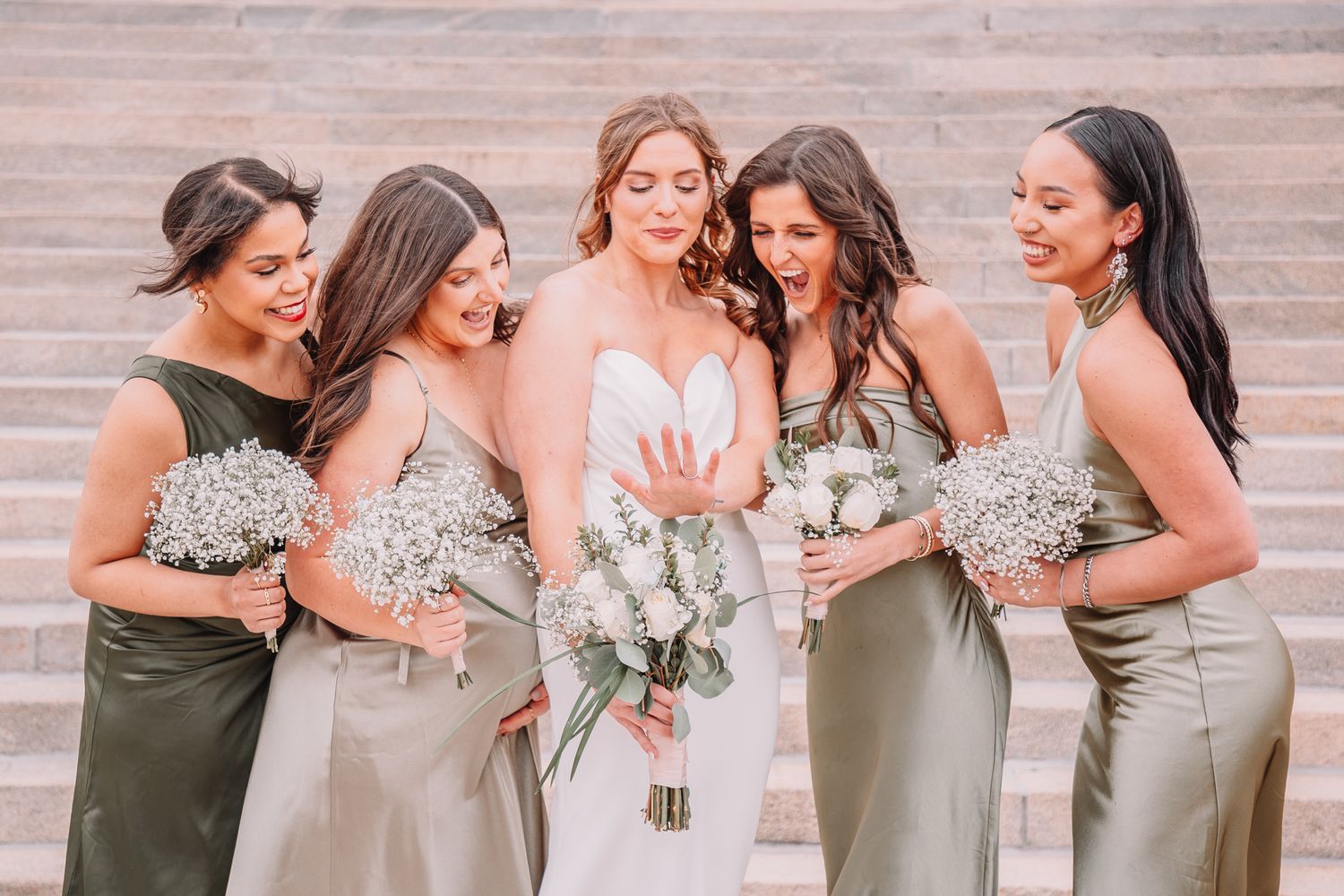 Wedding Portraits at the Topeka, KS Capitol building. Wedding party Portraits. Bride and bridesmaids looking at ring.