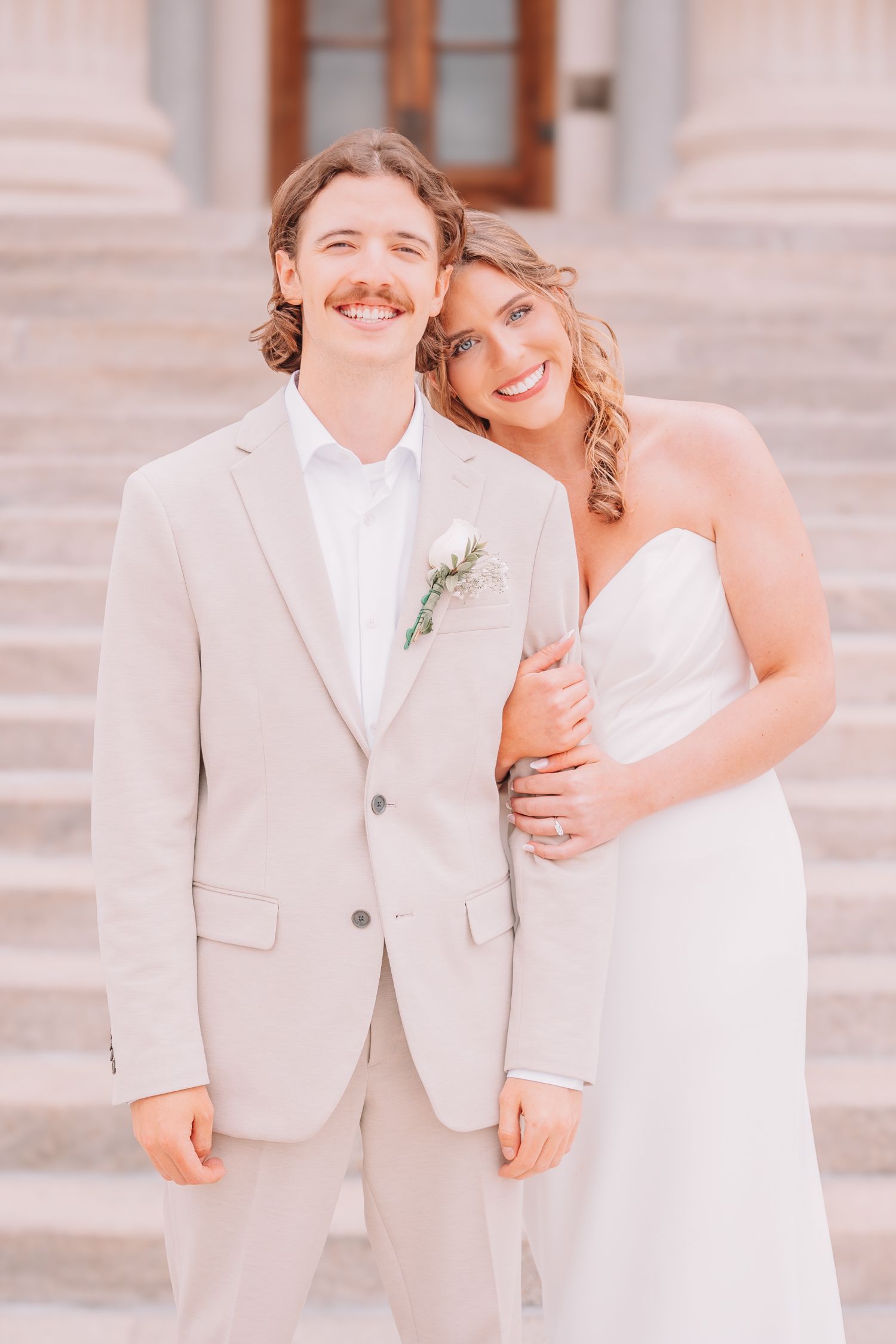 Romantic photo of bride and groom at the Topeka, KS Capitol. Wedding photos in Topeka, KS.