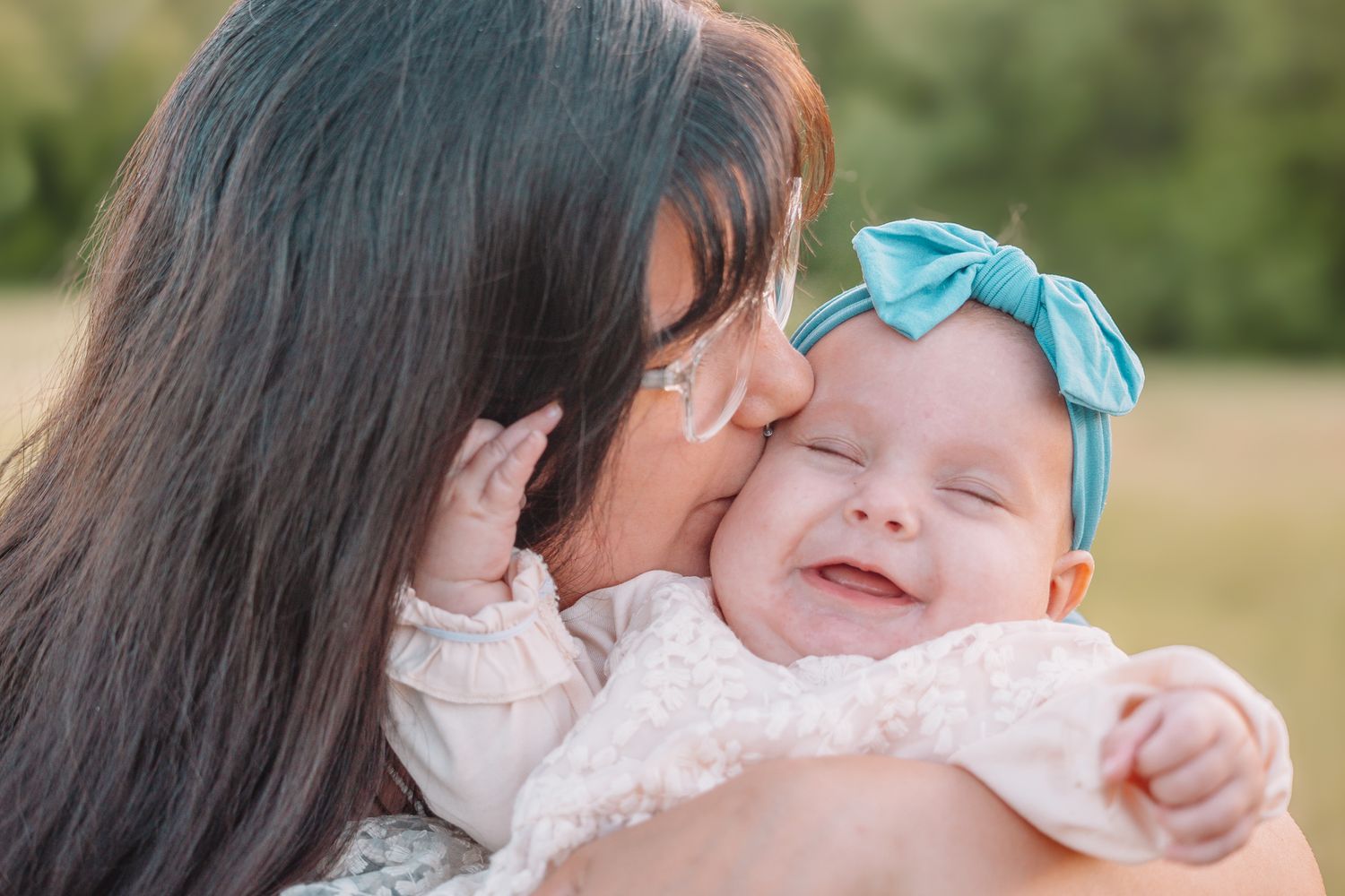 Mother kissing baby - family photos.
