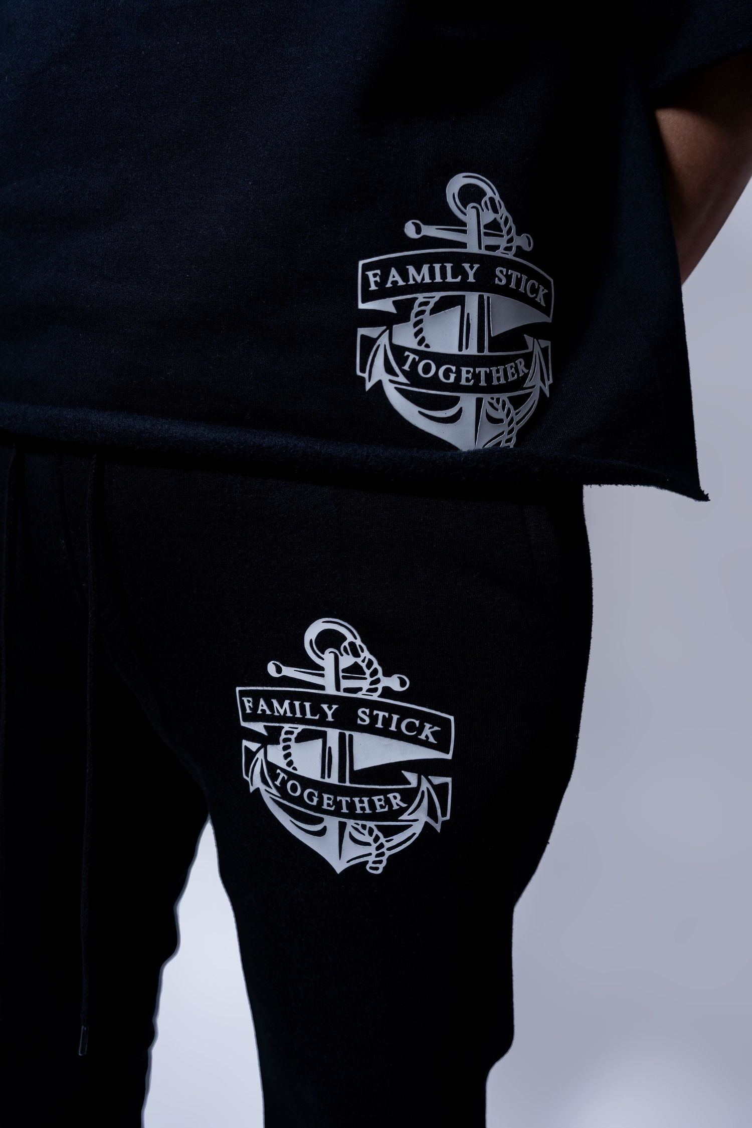 Black matching set with Family Stick Together anchor graphic on t-shirt and shorts.