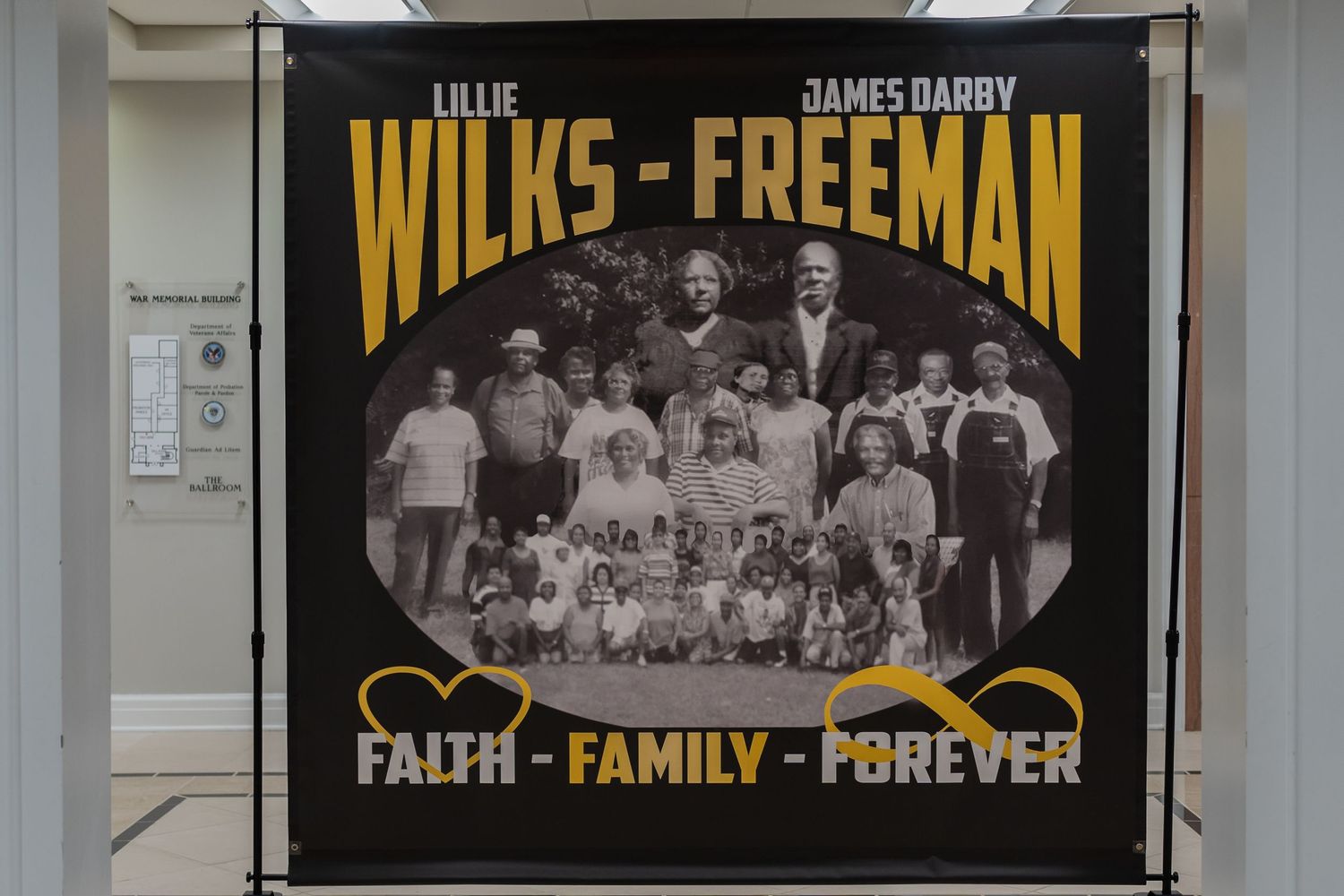 A banner honoring Lillie Wilks-Freeman and James Darby Freeman with the motto Faith Family Forever.
