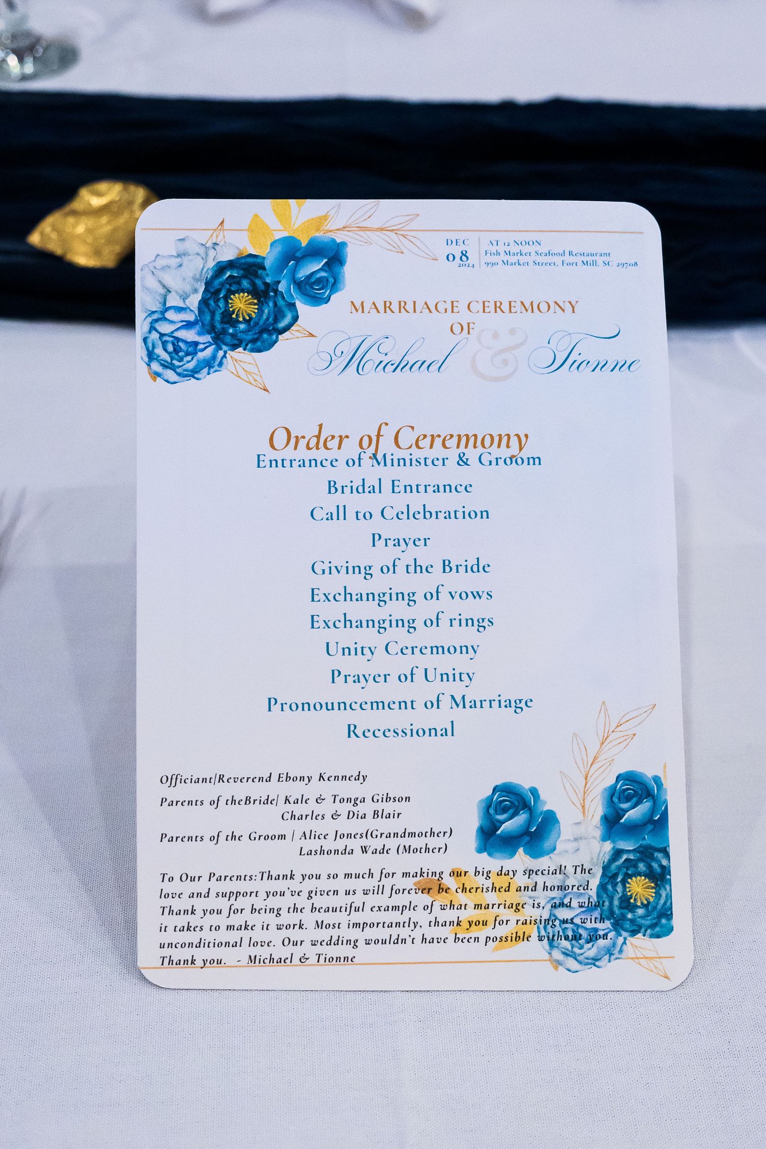Elegant wedding ceremony program for Michael and Tionne Jones dated December 8th, featuring blue floral design and order of service.