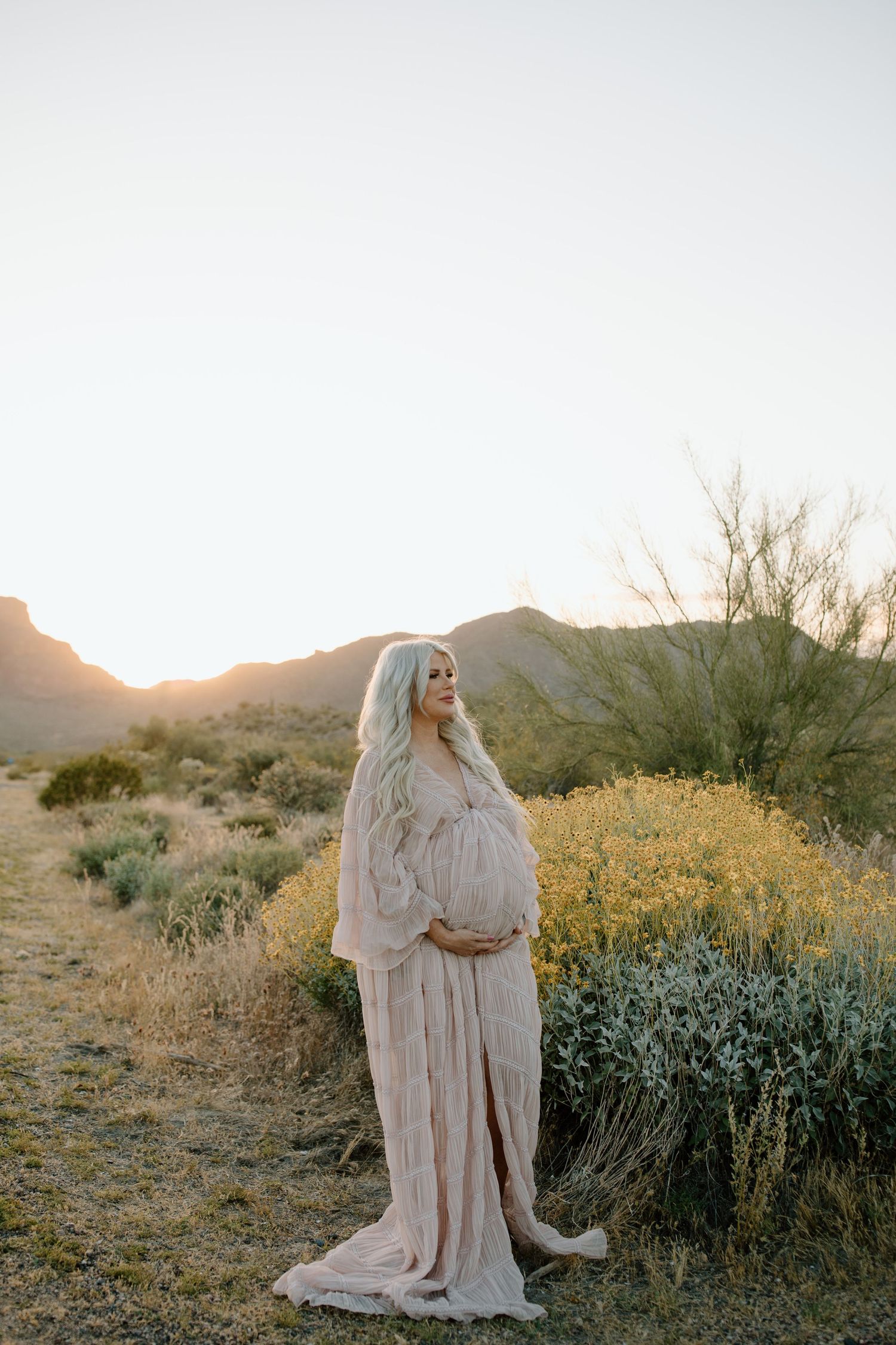 candid maternity shot outdoors Arizona desert golden hour