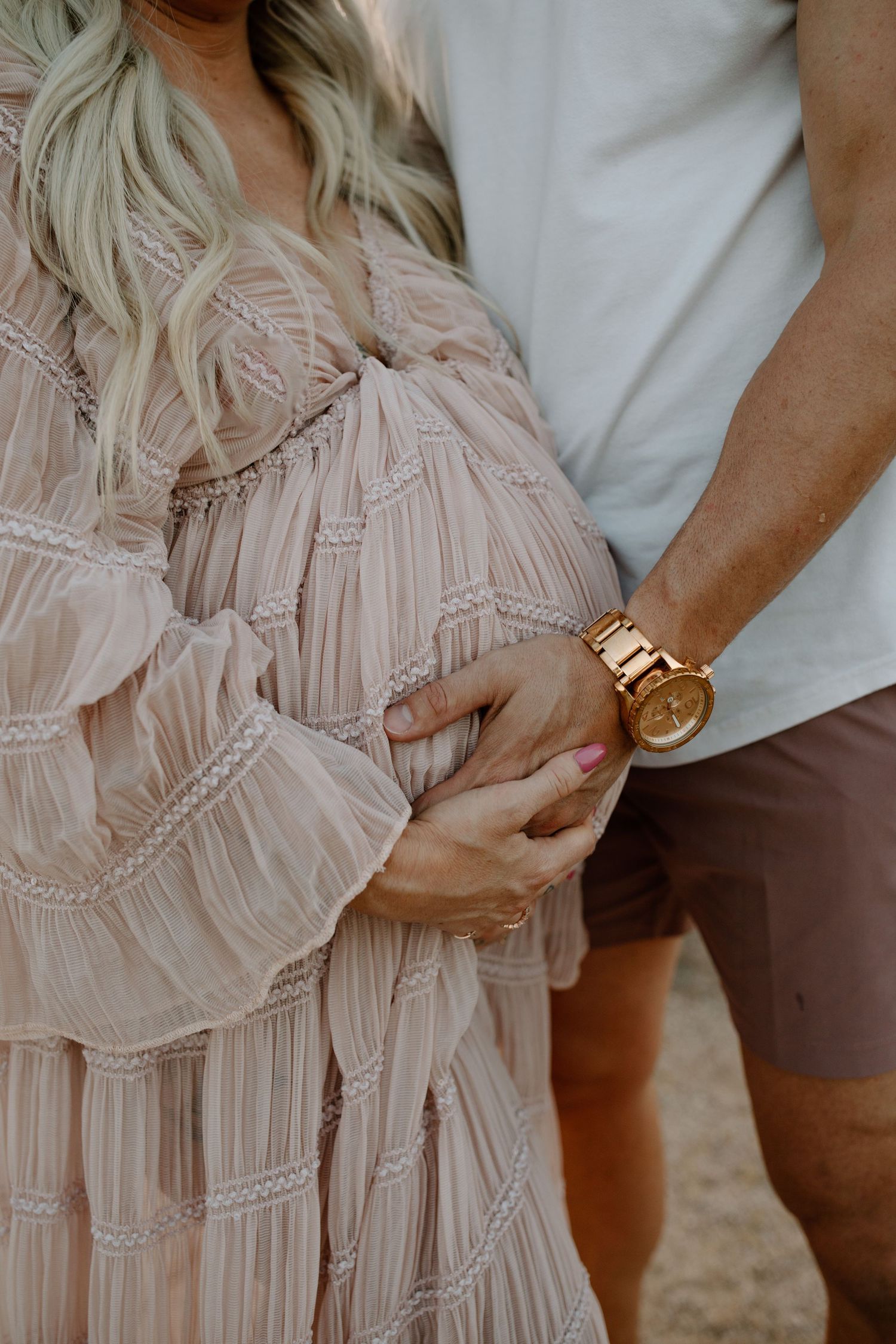 close up of maternity photos with husband and wife, mother and father, baby bump