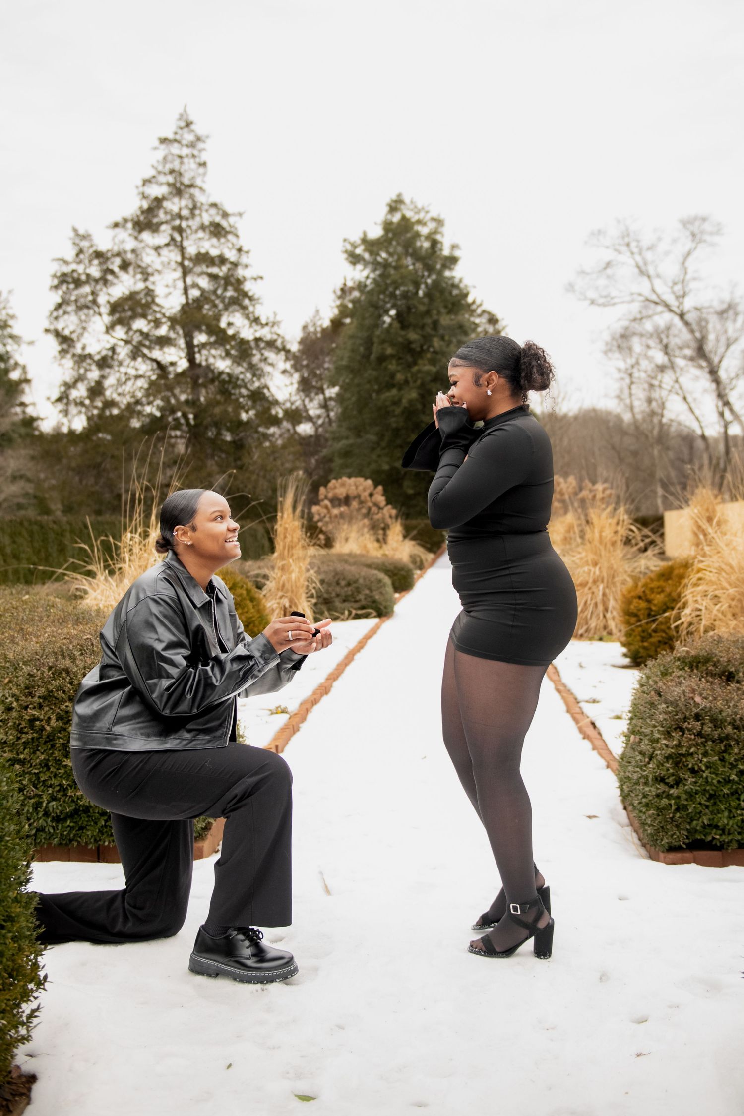 A couple shares a romantic proposal moment in the snow during winter, captured in a sequence of photos.