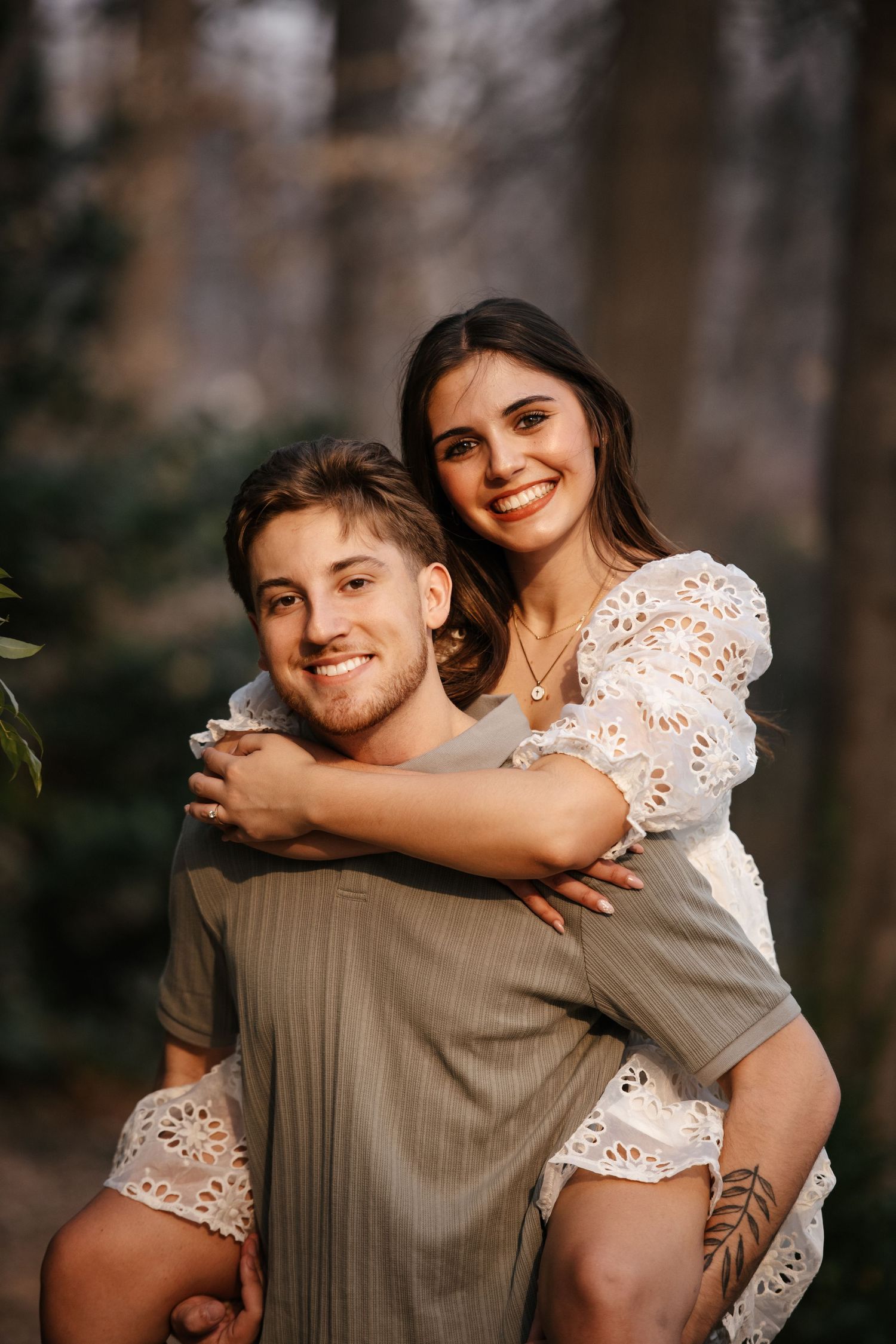 A couple shares playful piggyback moments in warm evening light.