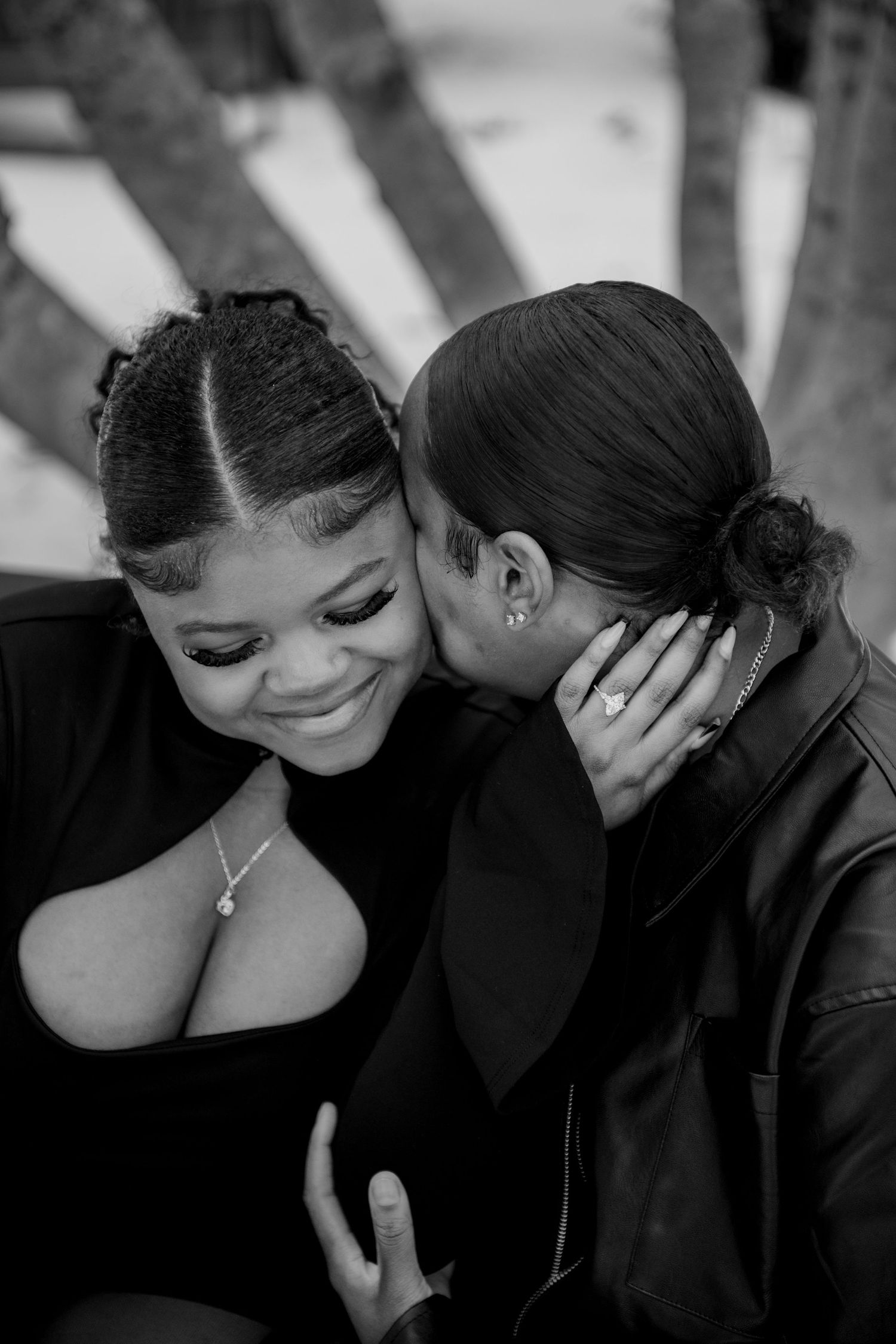 An intimate black and white portrait capturing a tender romantic moment between a couple.