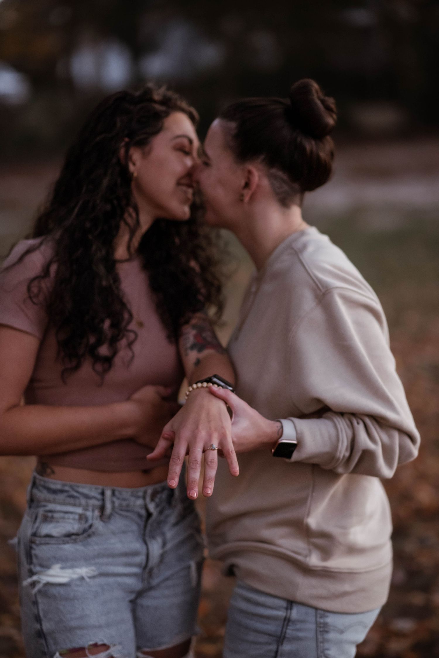 A romantic couple embracing and kissing in a series of intimate outdoor photos wearing casual clothing.