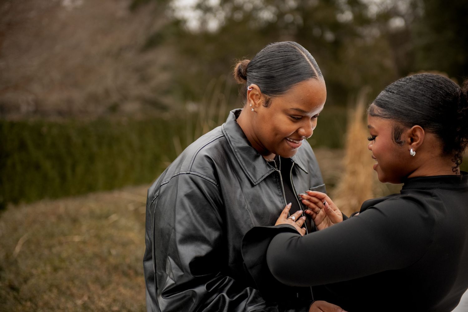 A tender moment between two people sharing a heartfelt exchange outdoors in natural lighting.