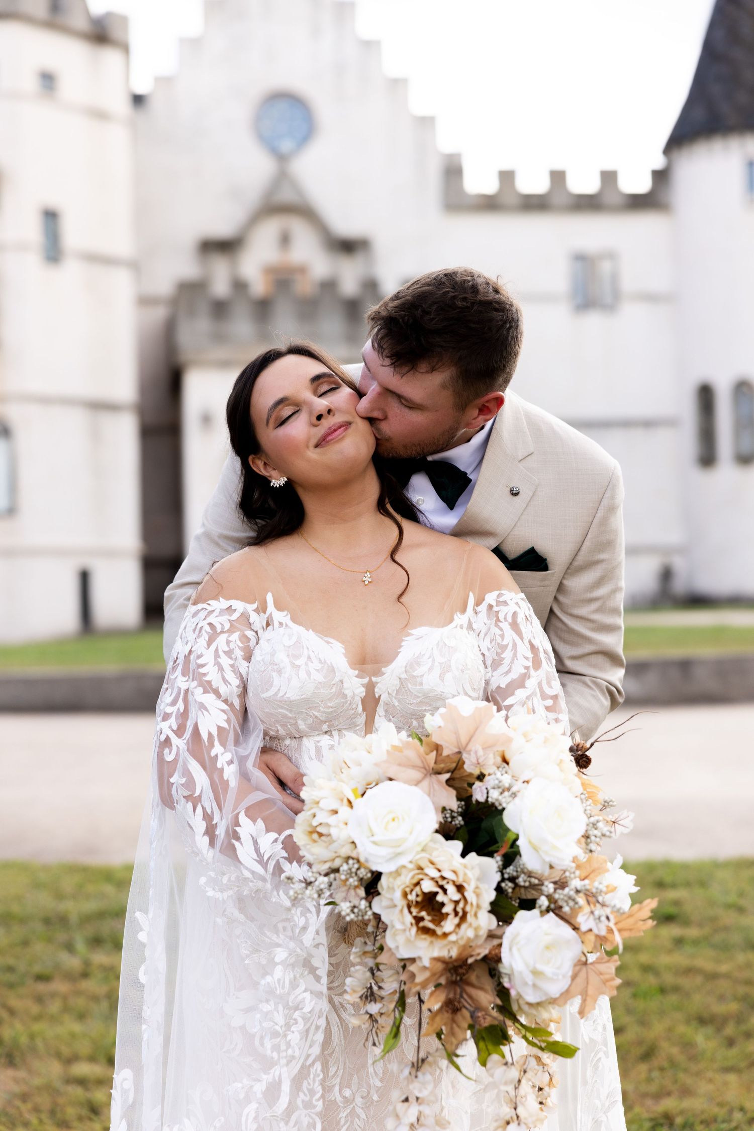 Groom kissing brides cheek at wedding