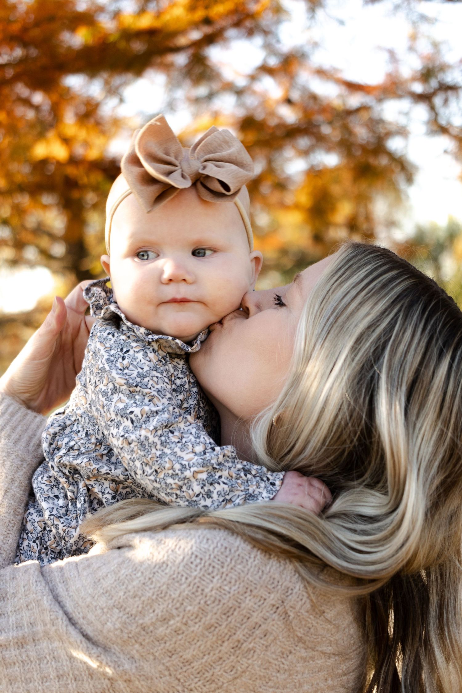 Sweet autumn outdoor portrait with warm golden lighting and fall foliage.