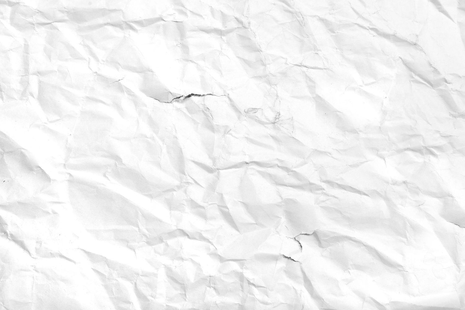Crumpled white paper texture background with wrinkles and folds, ideal for design projects.