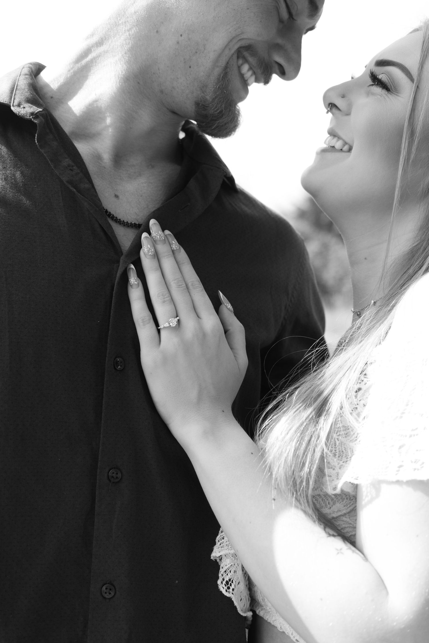 Intimate black and white close-up shots of a couple in romantic poses.