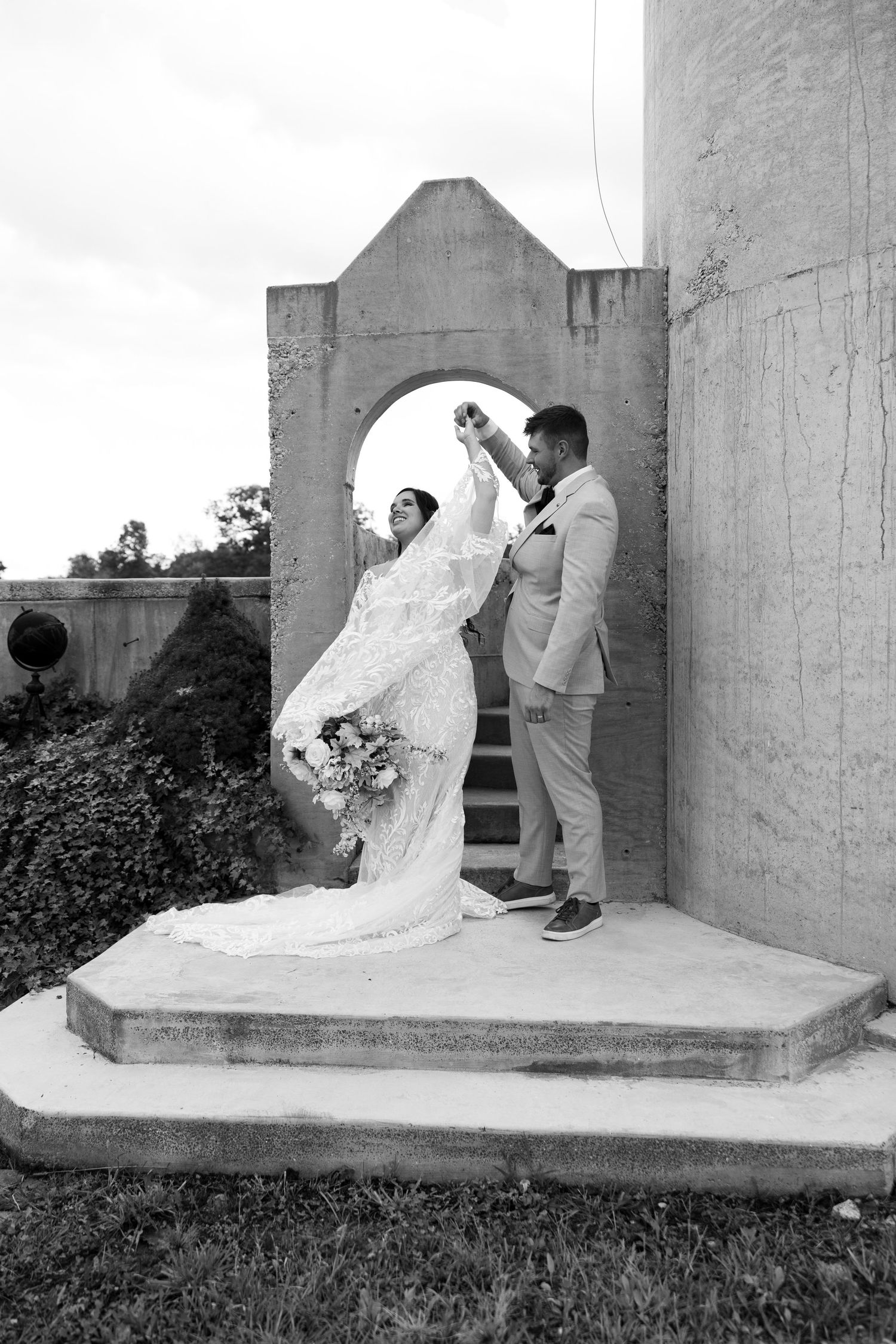 Groom spinning his bride on their wedding day.