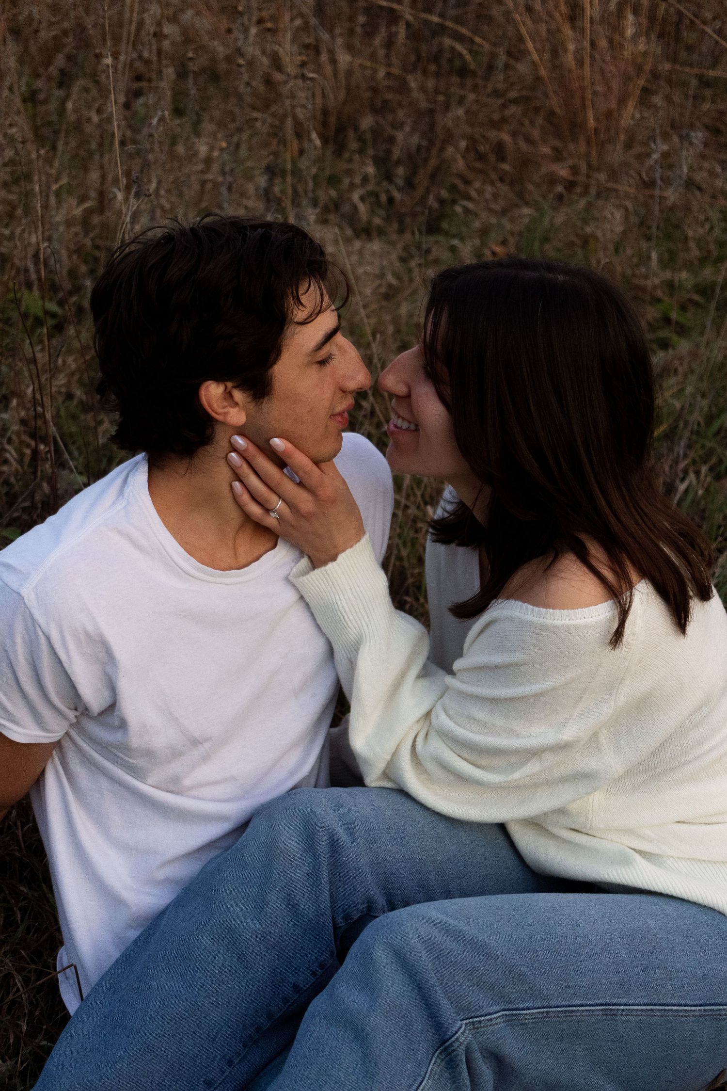 Romantic couple sharing intimate moments while sitting together outdoors.