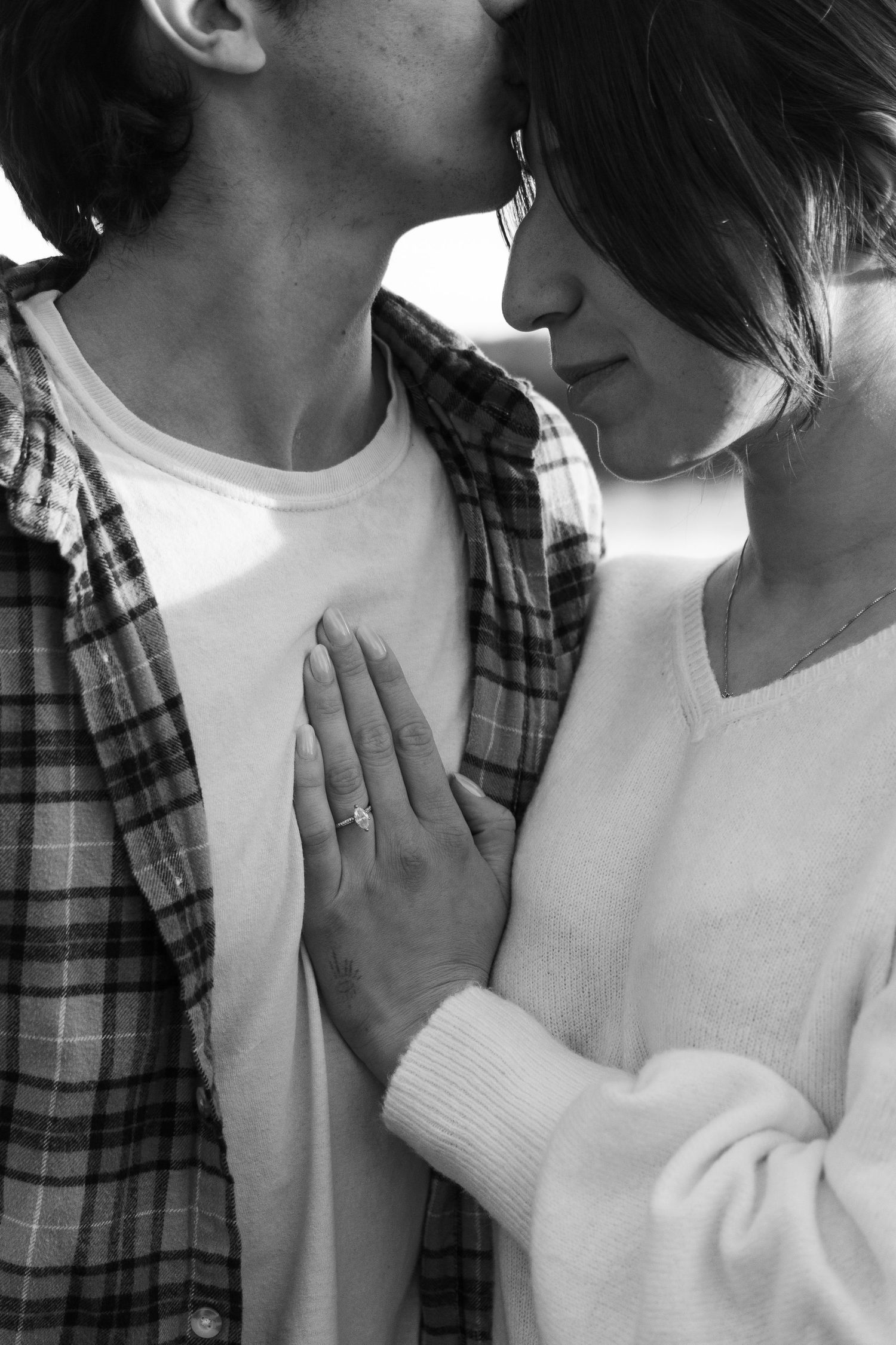 Close-up shots of a couple in white and plaid sharing tender moments.