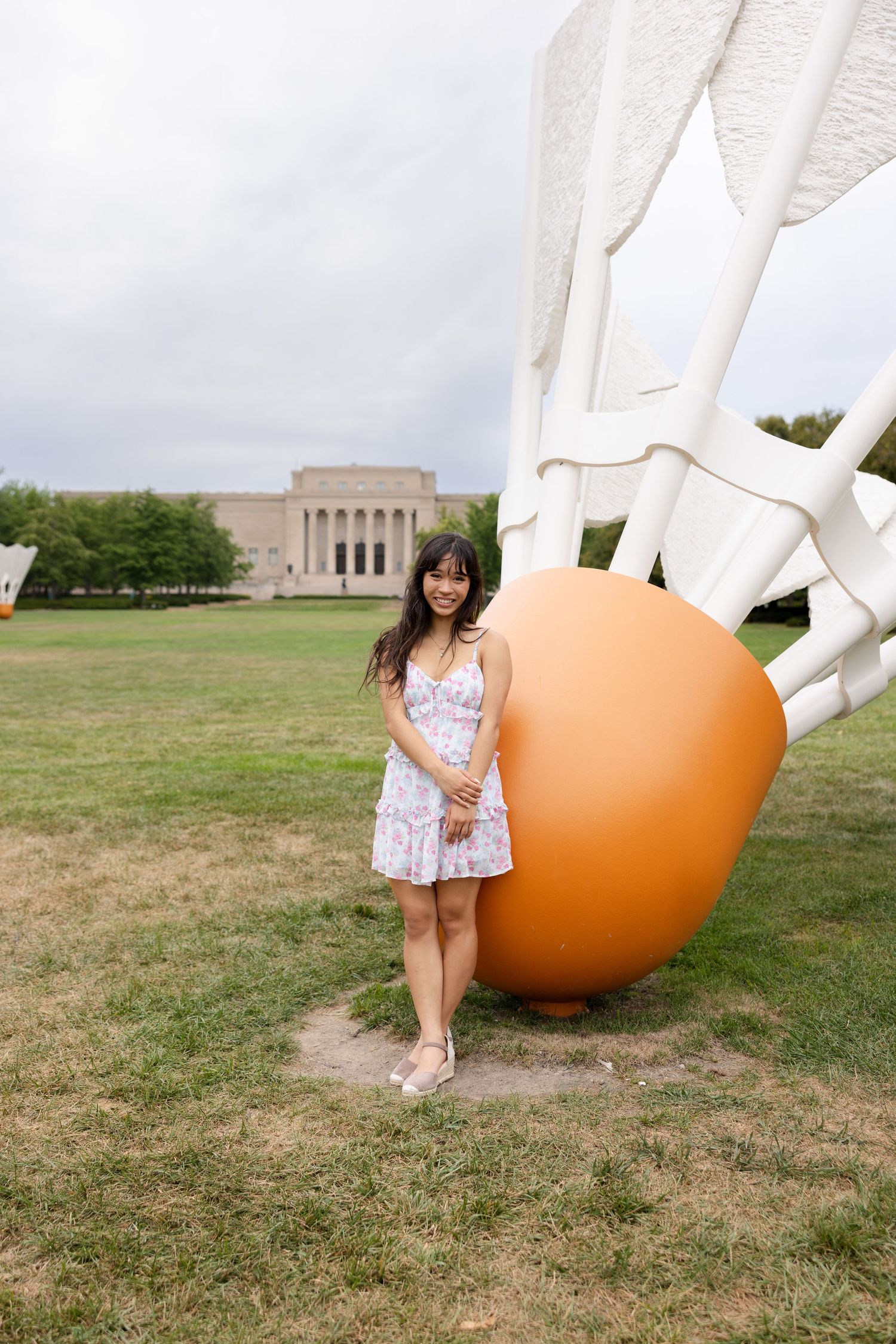 Senior standing by big birdie at Nelson Atkins Museum