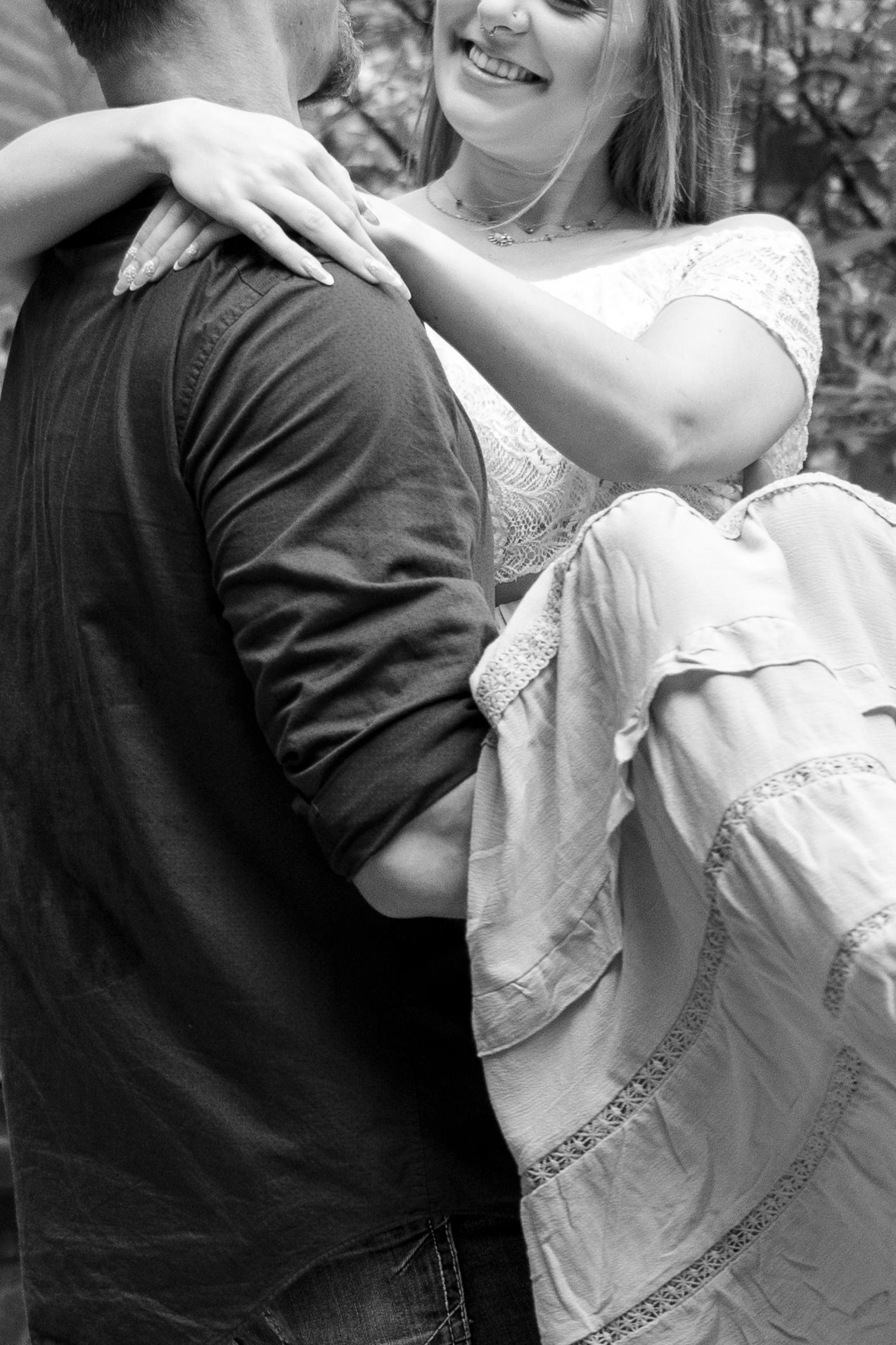 A black and white photo captures a romantic dance moment between two people.
