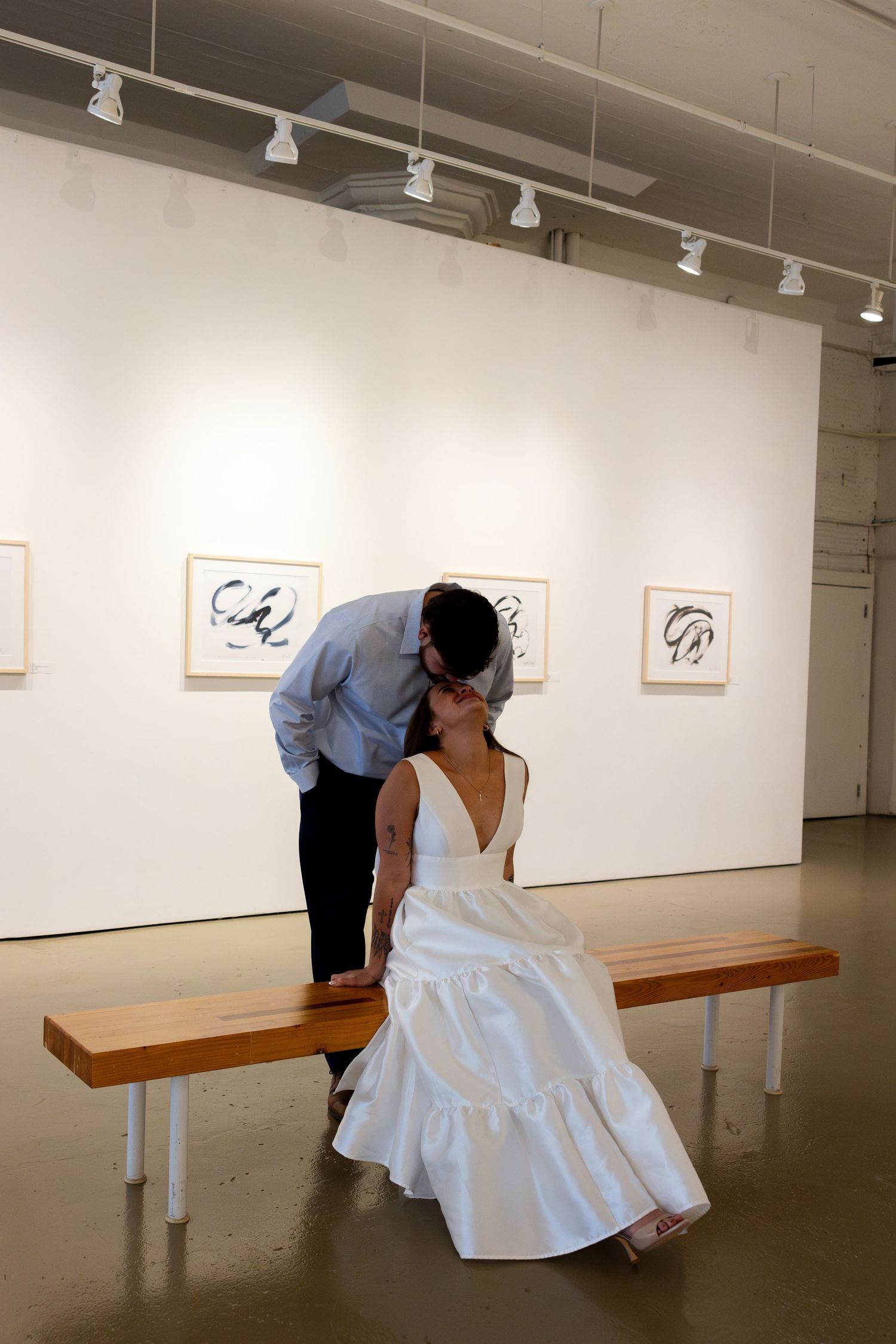 A sequence of images shows a person in a white dress examining artwork displayed on gallery walls.