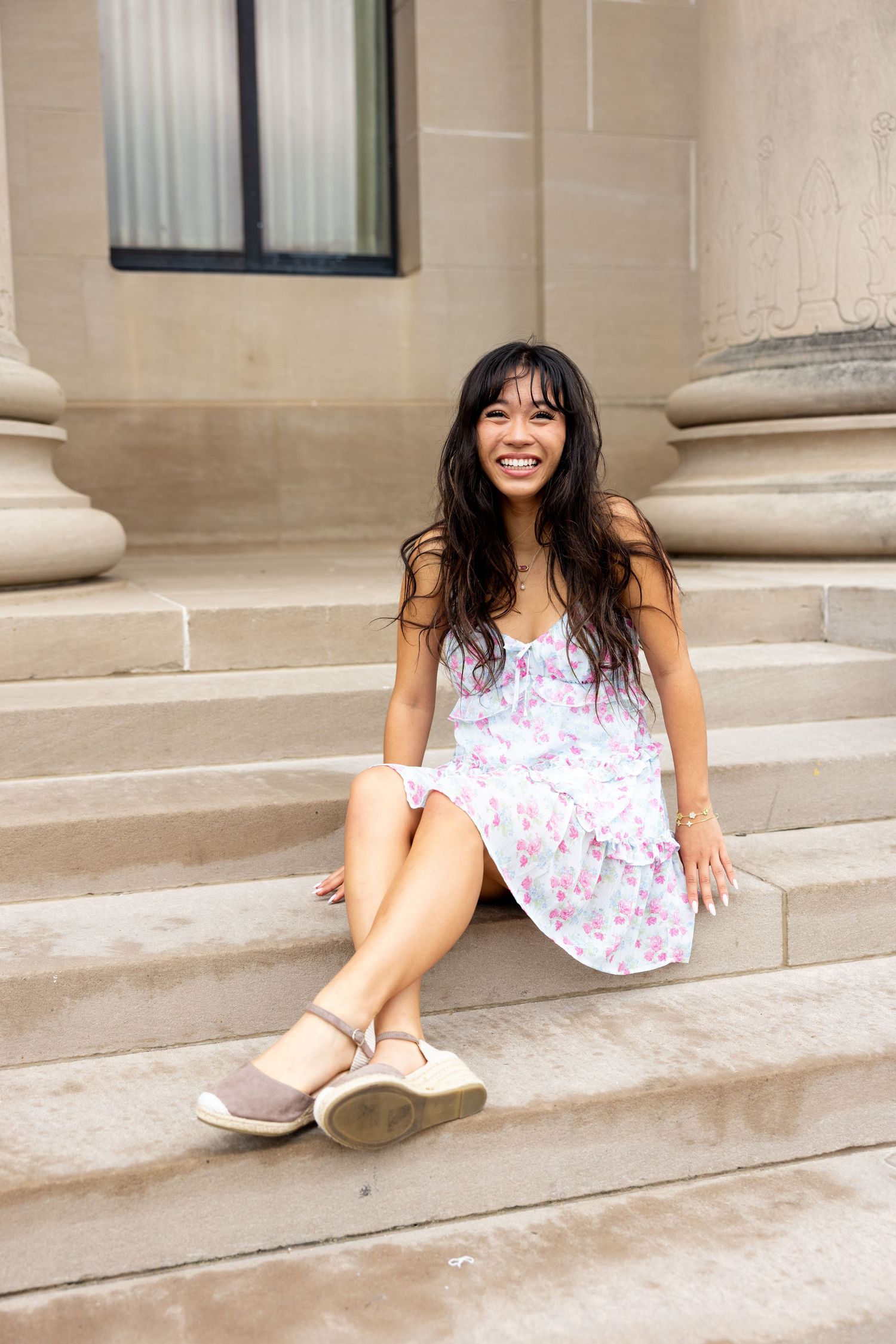 Senior sitting and laughing on steps of Nelson Atkins Museum