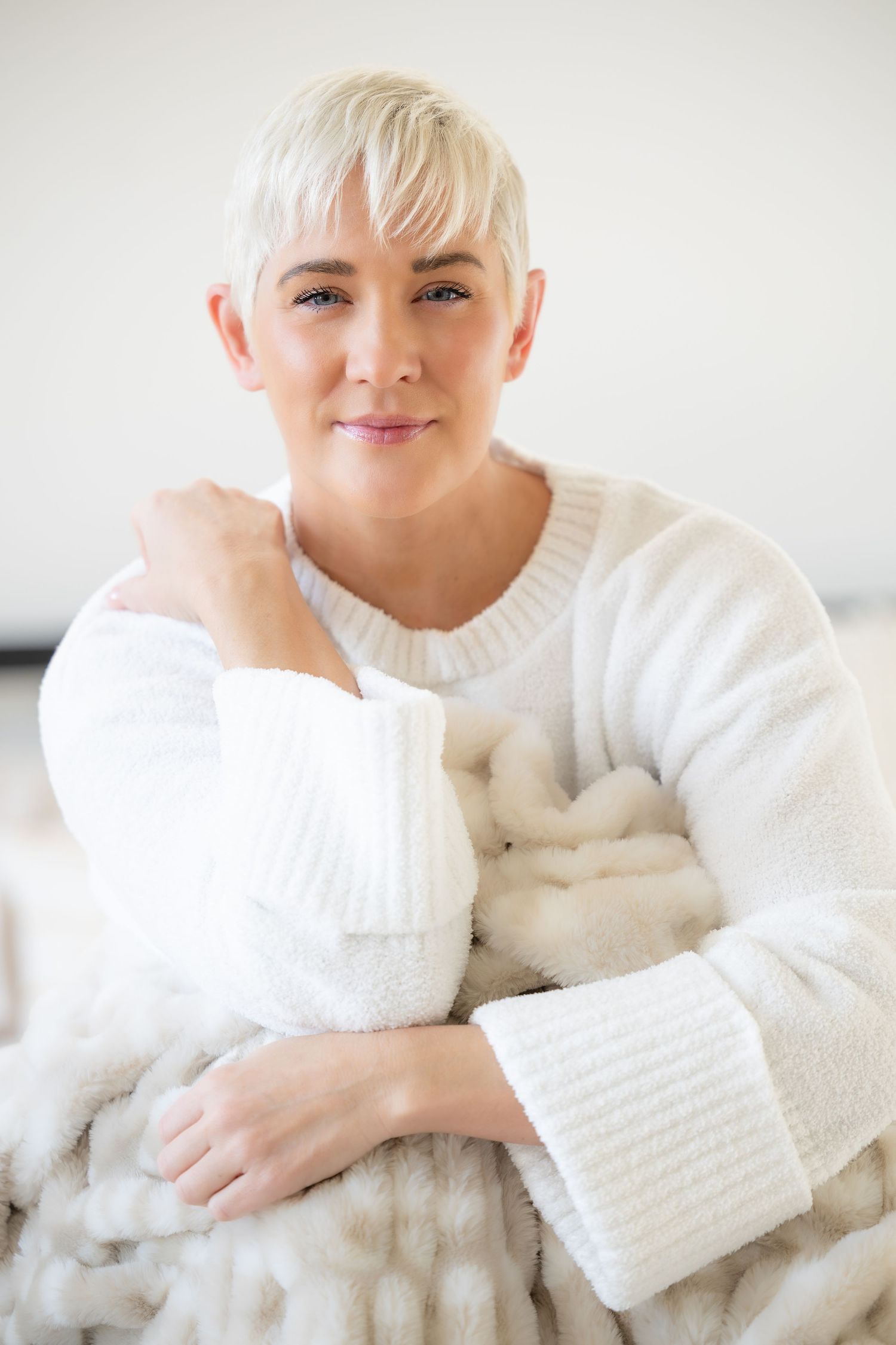 A series of close-up portraits showing someone wearing a cozy white sweater against a light background.