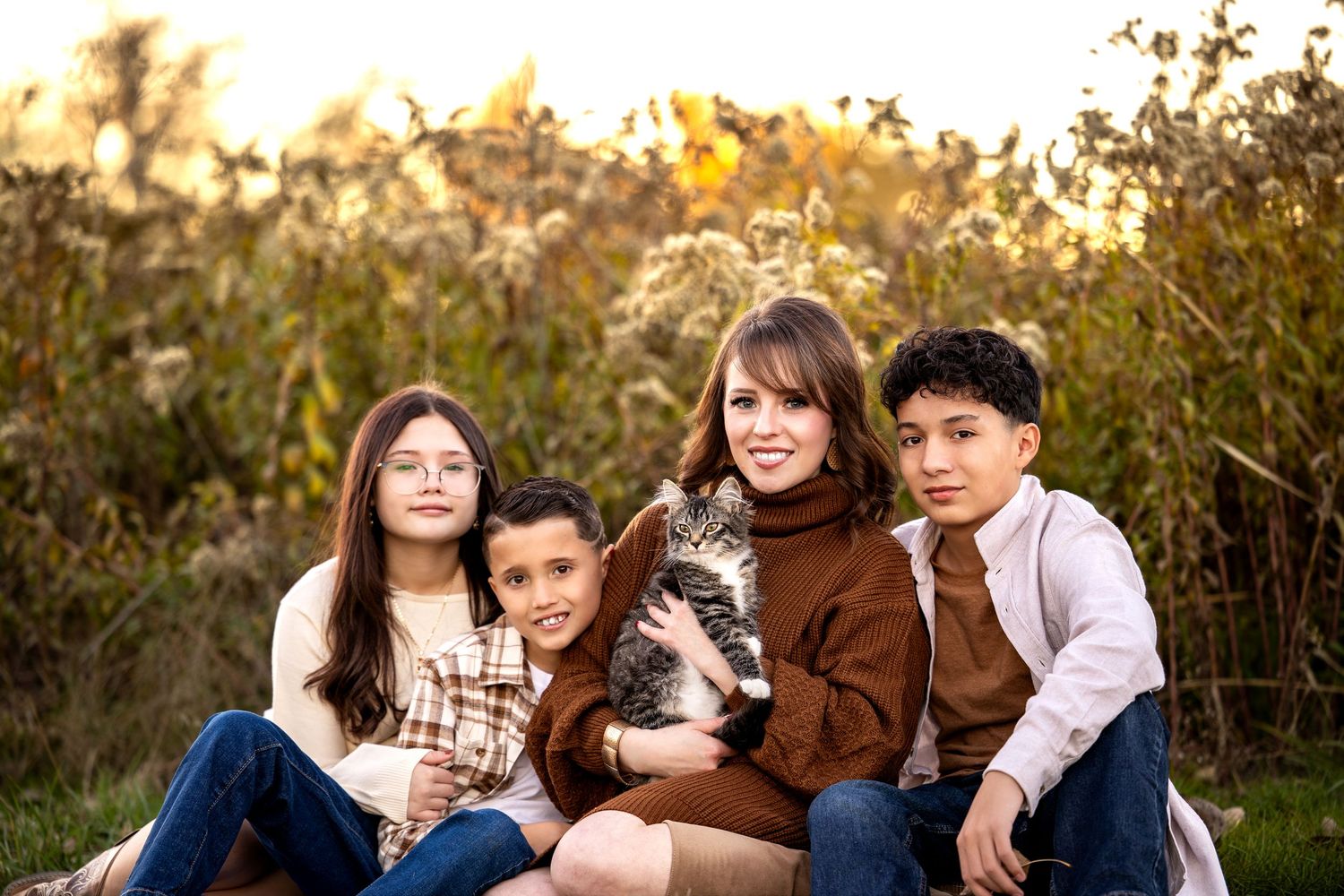 A series of outdoor family portraits showing warm interactions and smiles against a natural autumn backdrop.