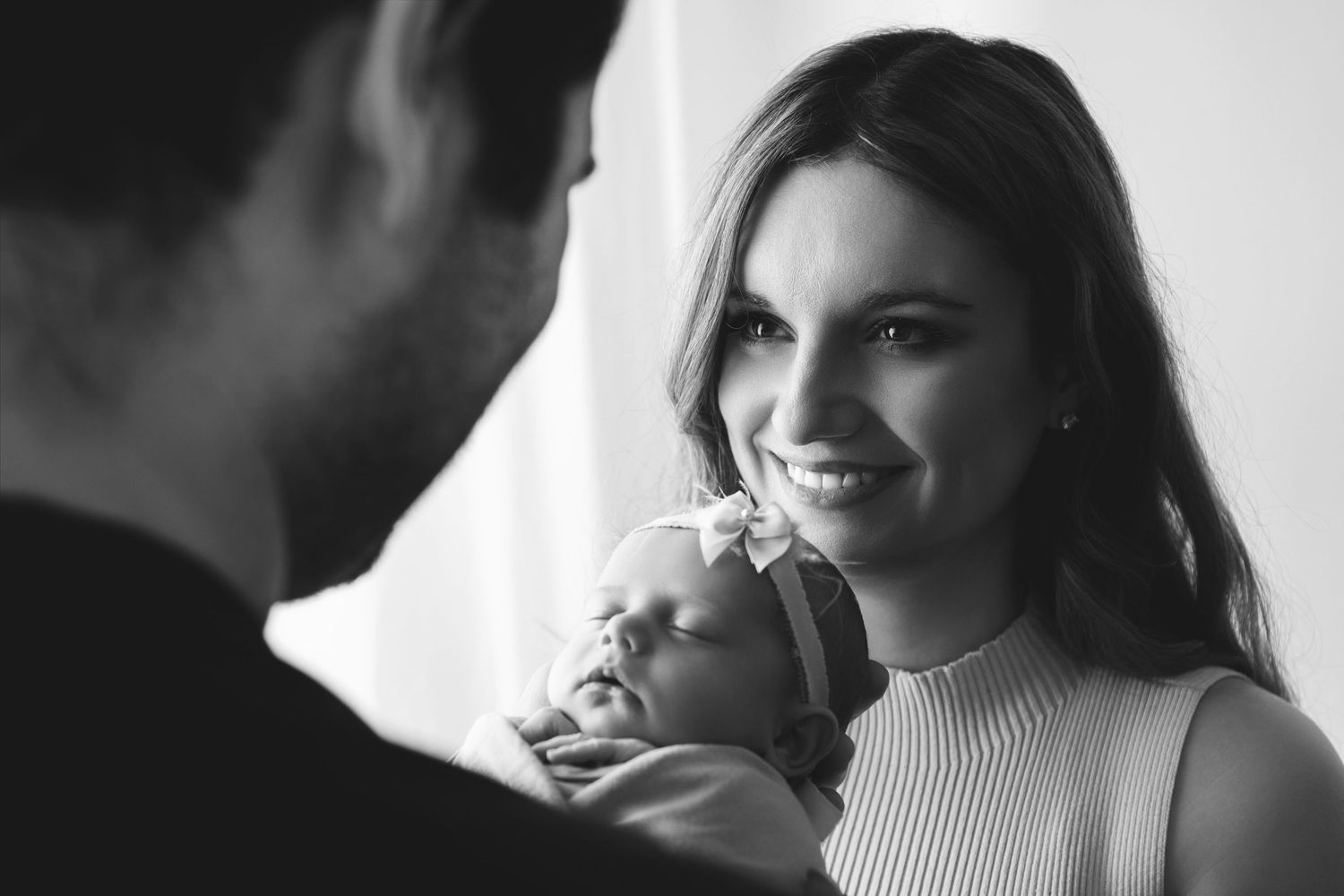 Black and white photo sequence showing a couple sharing intimate moments and laughter together.