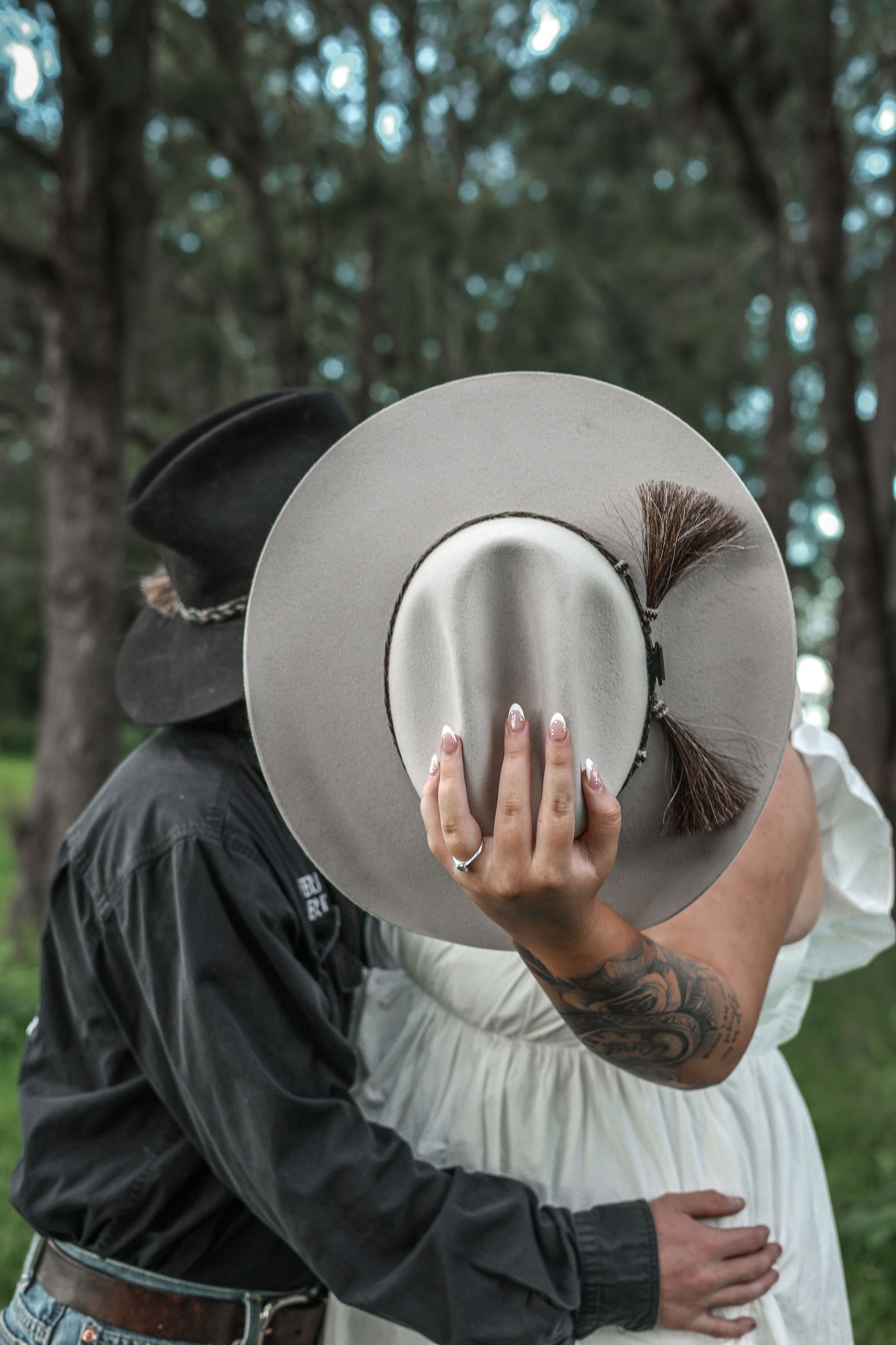 A person wearing a wide-brimmed hat leans forward in a sequence of photos showing off their engagement ring