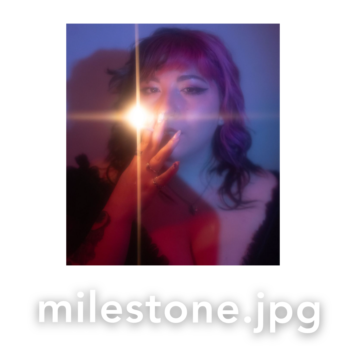A woman with colorful hair poses dramatically with a bright lens flare light effect in a moody blue-toned portrait.